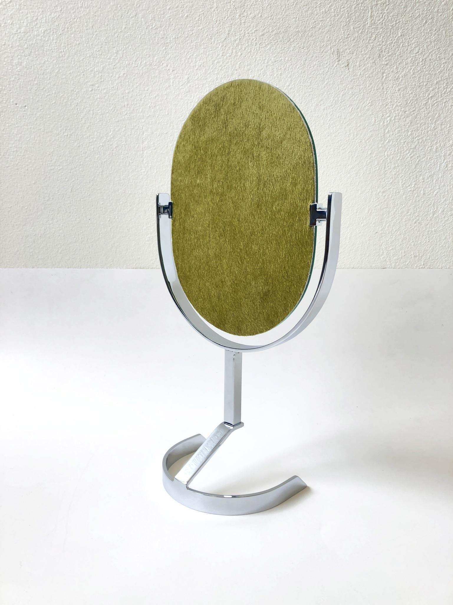 A glamorous 1970s polish chrome and olive green pony skin with hair vanity mirror in the manner of Charles Hollis Jones. The mirror can be replated brass if desired for an extra cost.
Overall dimensions: 21.5” high 12” wide 6” deep.