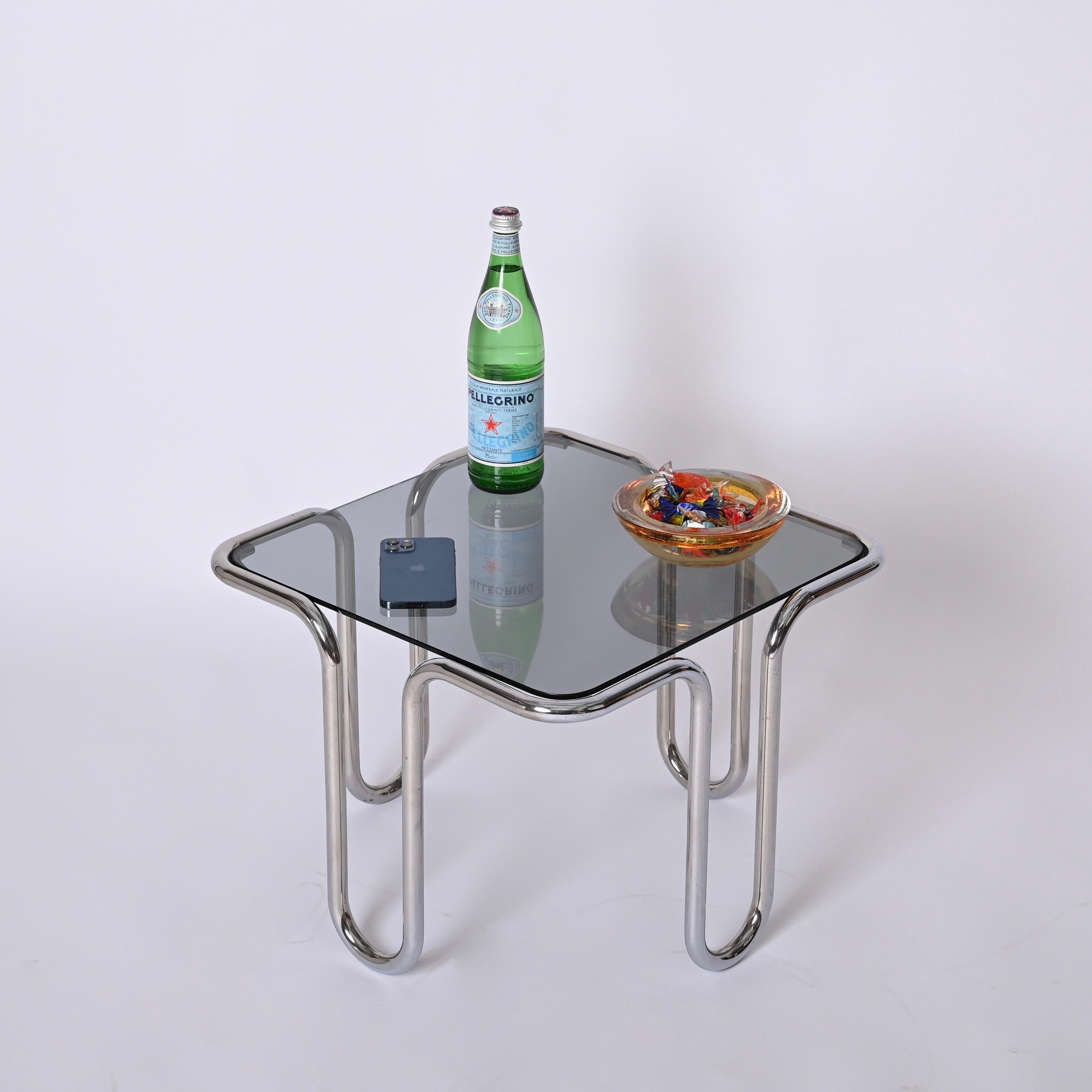 Beautiful coffee table designed by Ezio Didione in Italy in the 1970s.

This elegant square table feature a tubular curved base chromed metal with a smoked glass top.

A minimal coffee table perfect for a mid-century modern living room.

Measures in