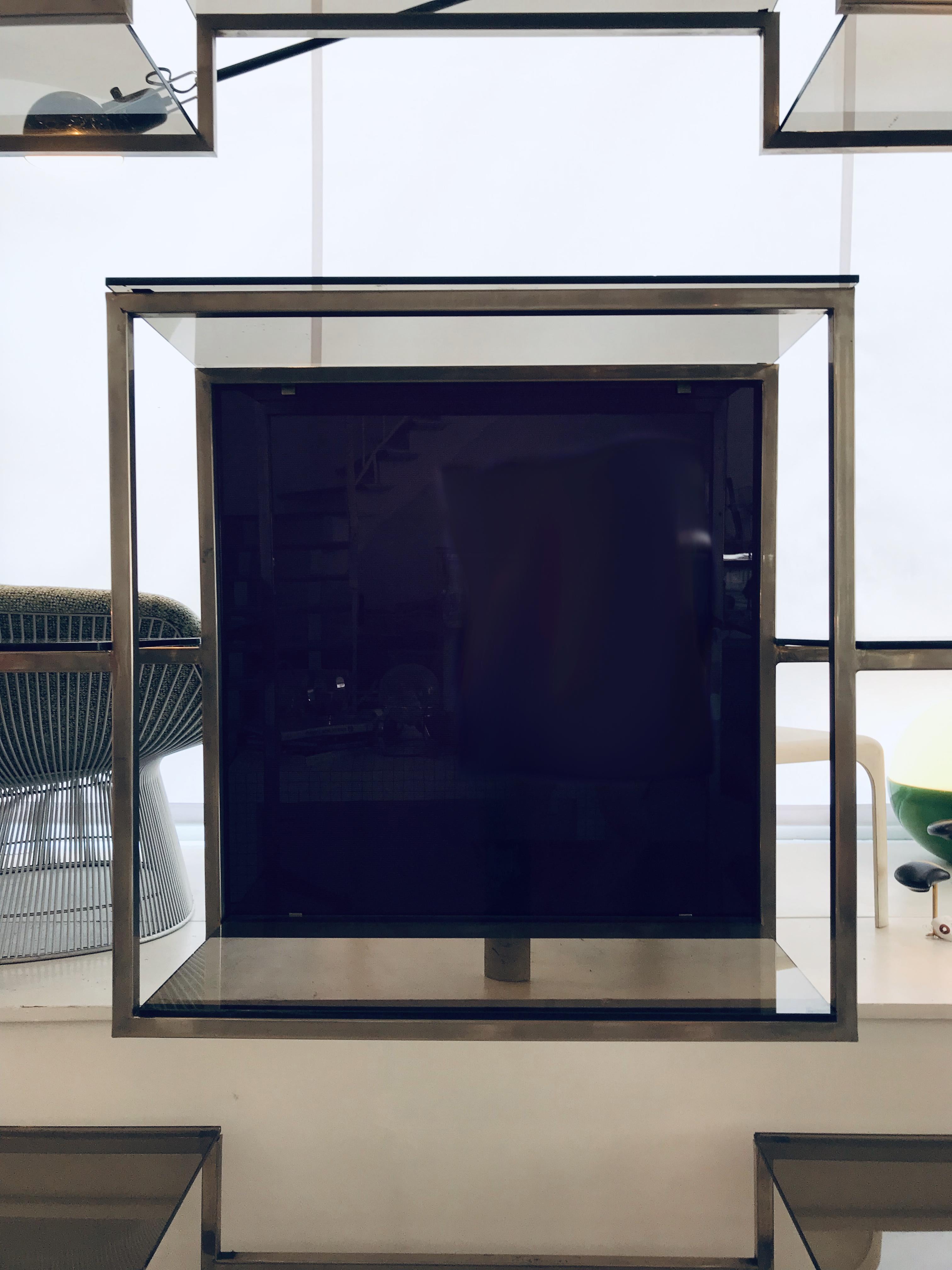 Chrome and smoked glass shelf, in the style of Maison Jansen
Gray plank and purple square as background surface,
circa 1970.
 