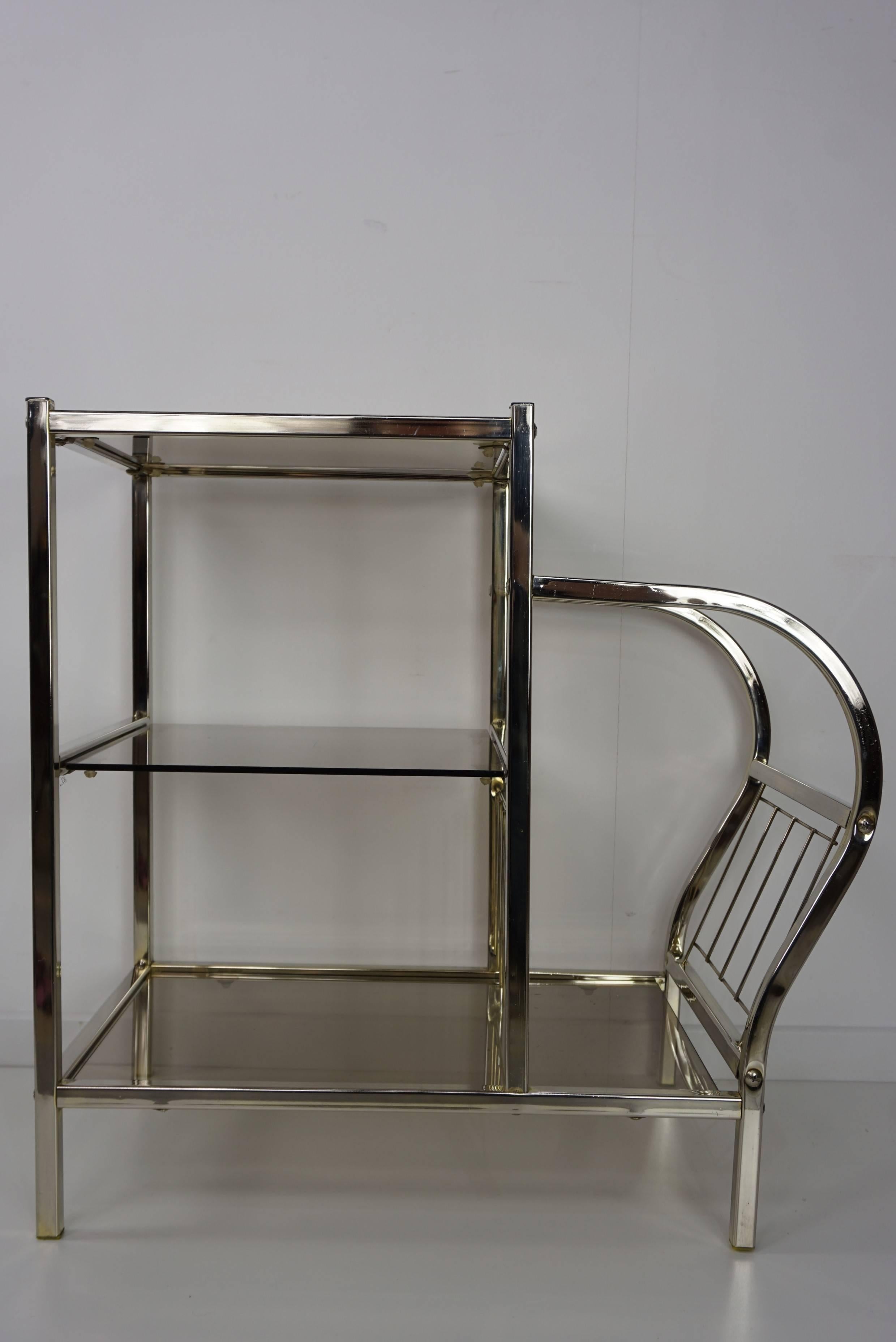 Brilliant and sparkling chrome sofa table and integrated magazine rack with 3 storage levels in smoked glass top.