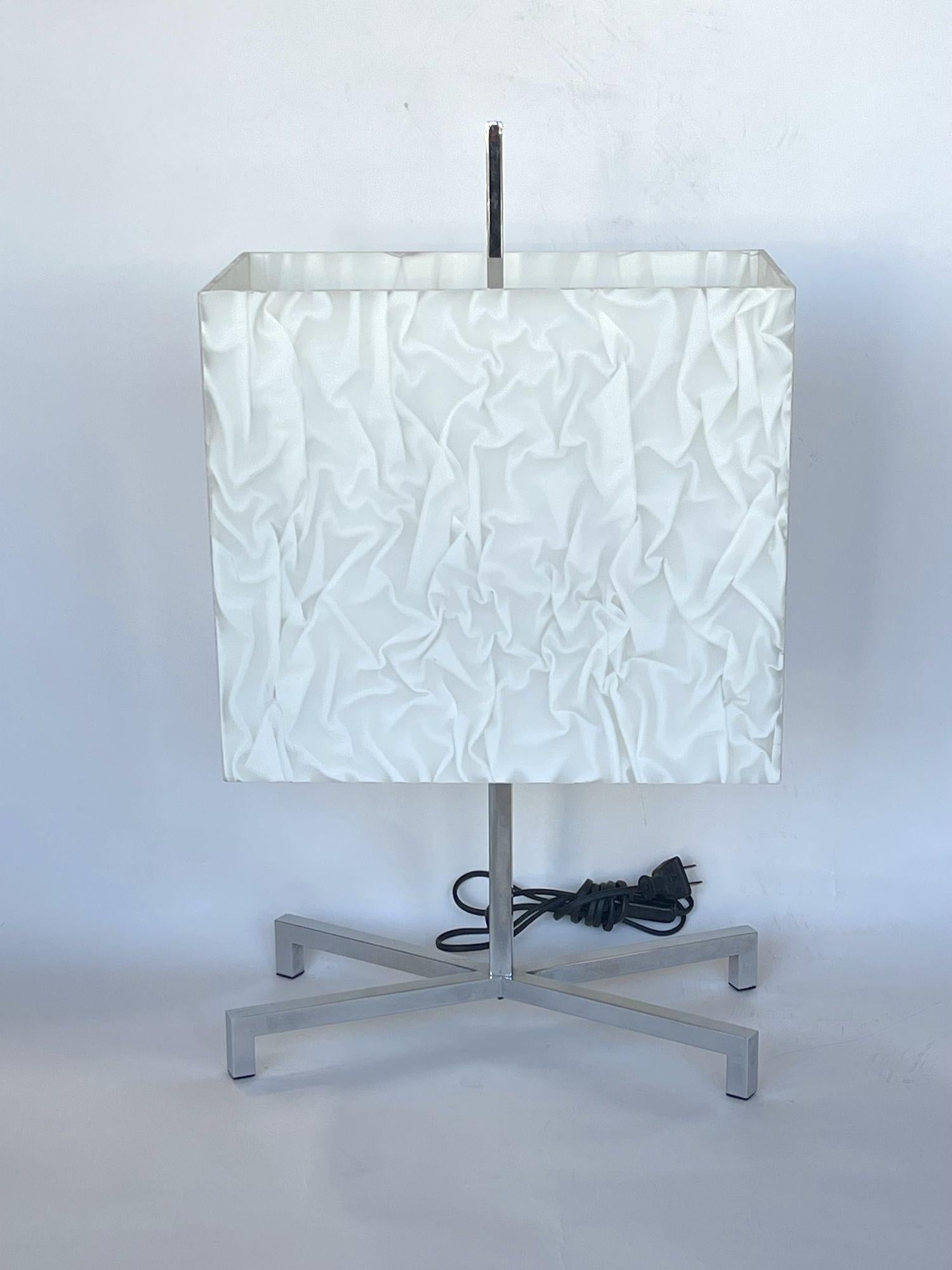 Gorgeous lucite and chrome table lamp by Fontana Arte. White lucite shade has patterned 