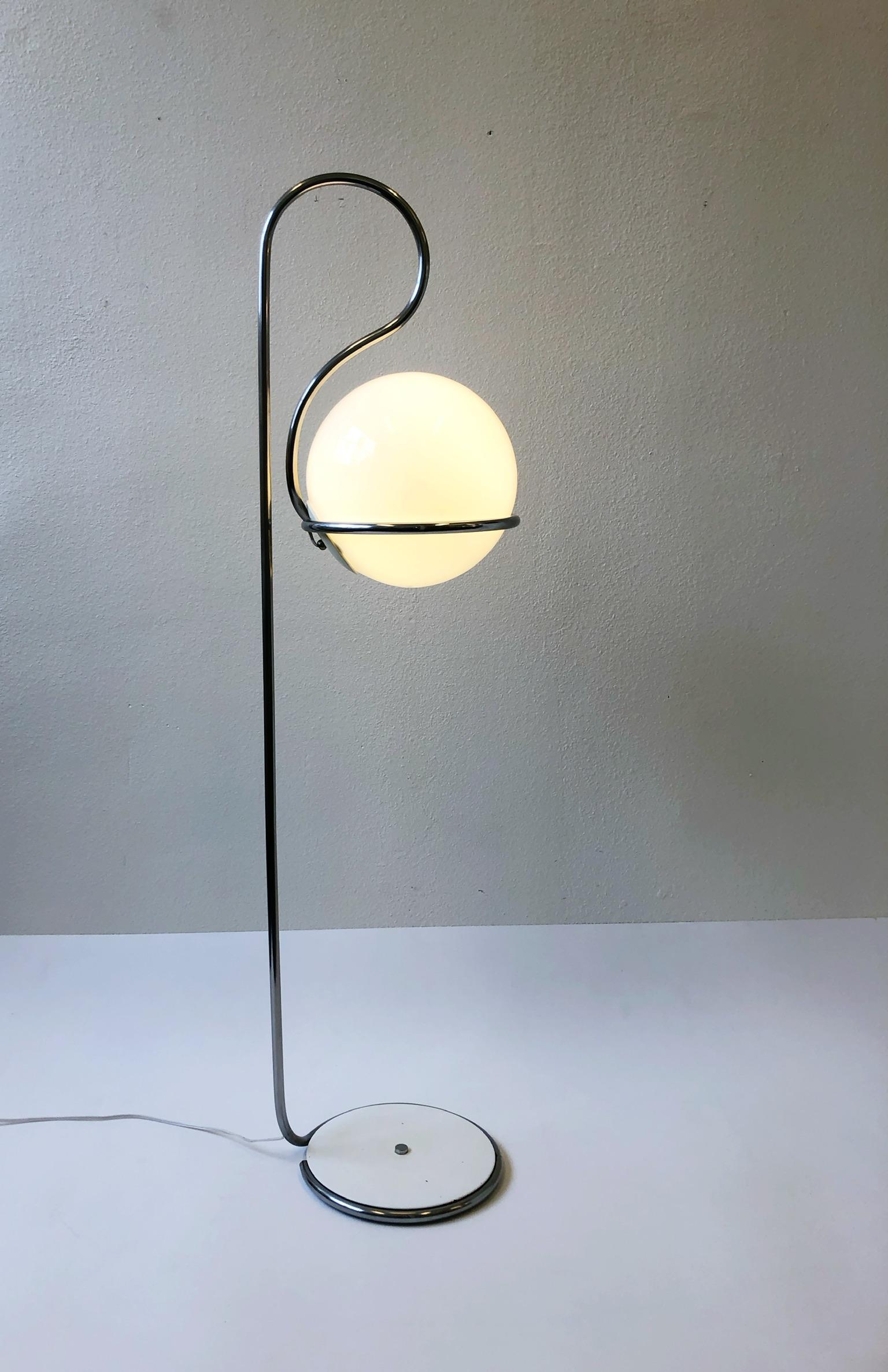 A vintage 1970s Mod floor lamp on the Manner of Italian designer Fabio Lenci. The lamp is constructed of steel that’s polish chrome plated and the globe is glass. The lamp take a regular 75w Edison lightbulb. I would not recommend going higher than
