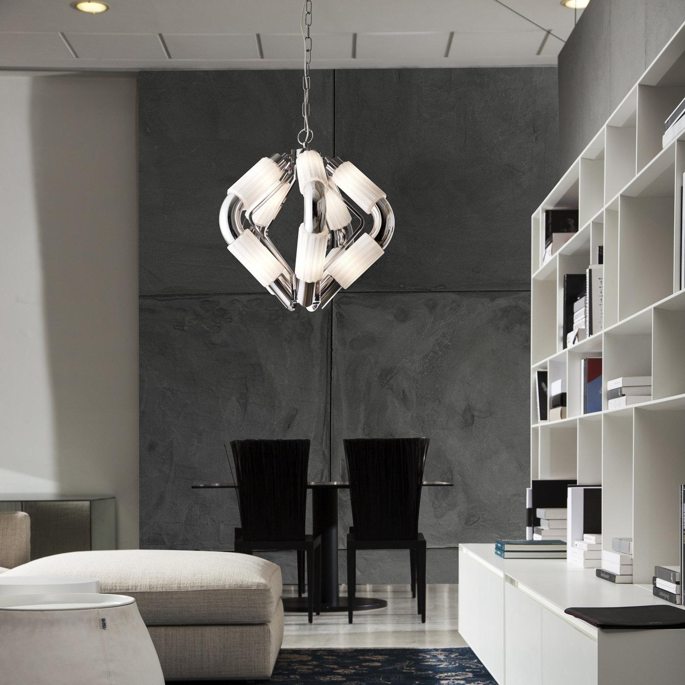 Featuring five bent cylindrical sections in metal with a bright chrome finish converging towards their extremities, this stunning pendant diffuses an intense and evocative light through the 10 cylindrical grooved shades in white glass hosting two