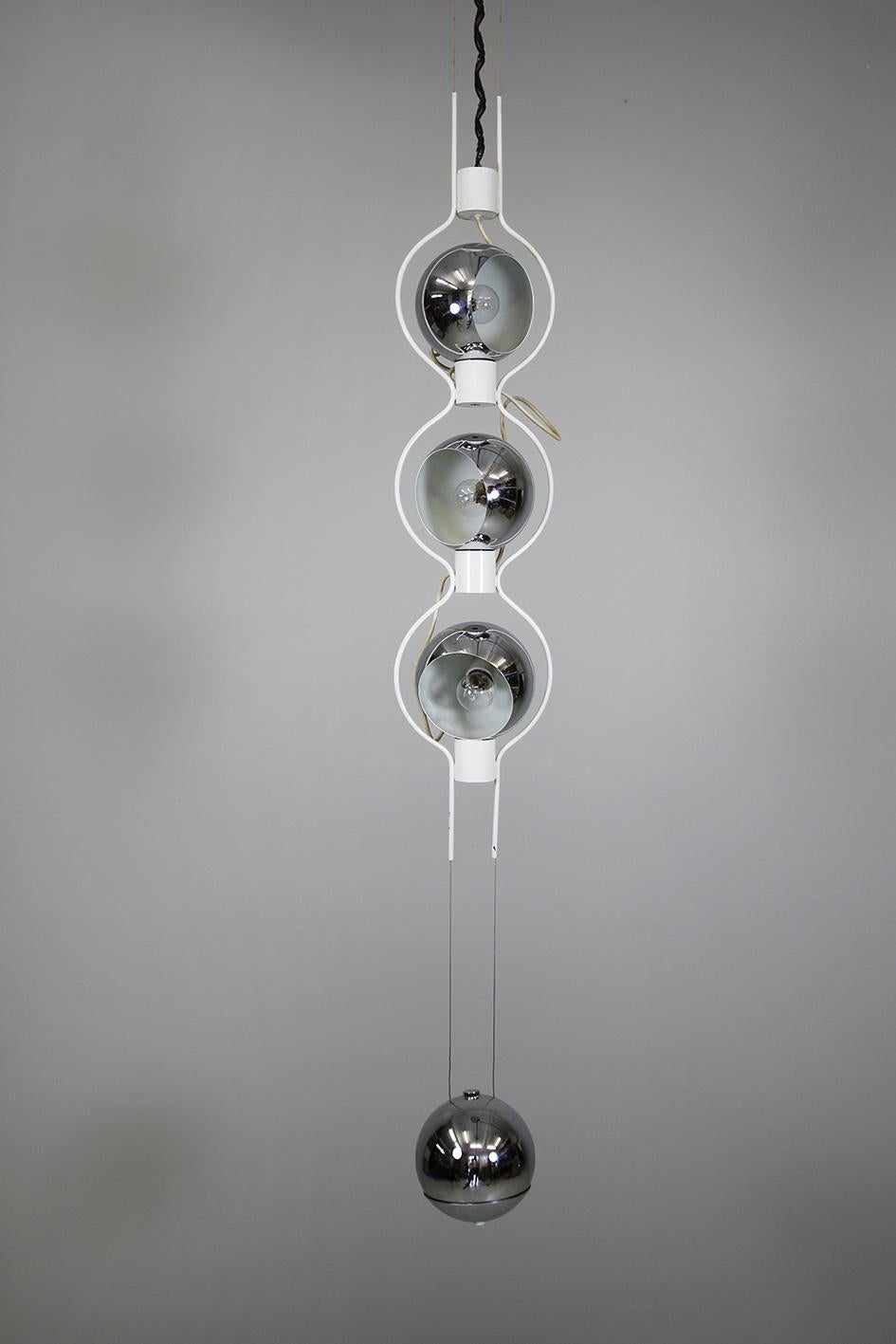 This very rare, complex yet easy ceiling lamp '14071' by Angelo Lelli is made of chrome and white lacquered metal. It has three light sources coming from round, spherical cones. The lamp is being balanced out by a weight also covered in chrome.