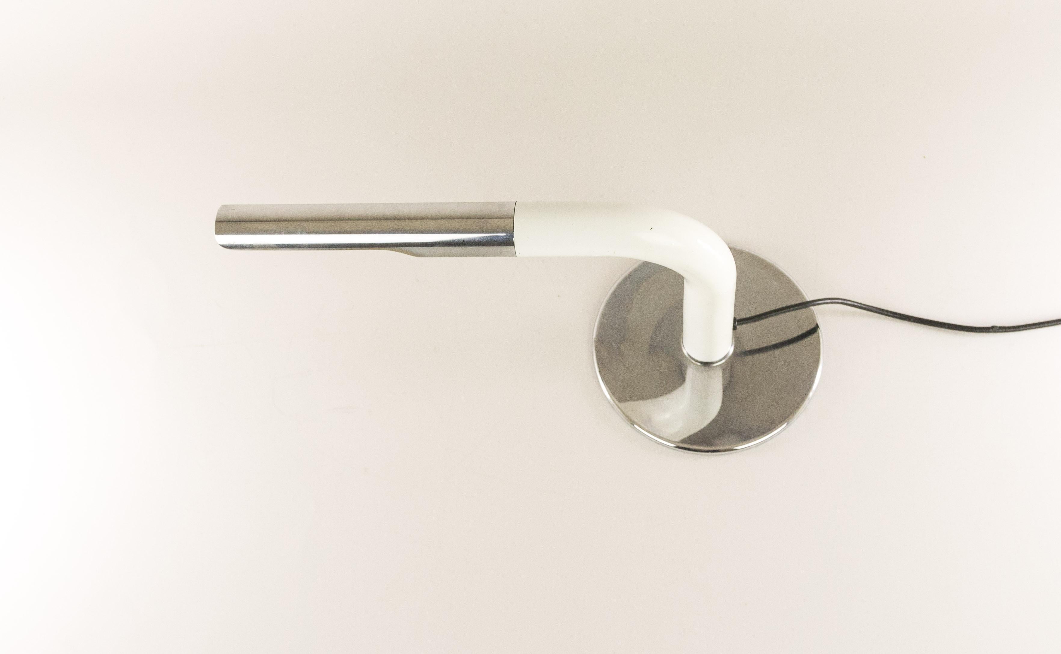 Table lamp model Gulp designed by Ingo Maurer and produced by his own company Design M.

The lamp was designed in 1969 and it is made of chrome and white lacquered metal. The condition of the lamp is good, with some minor wear consistent with age