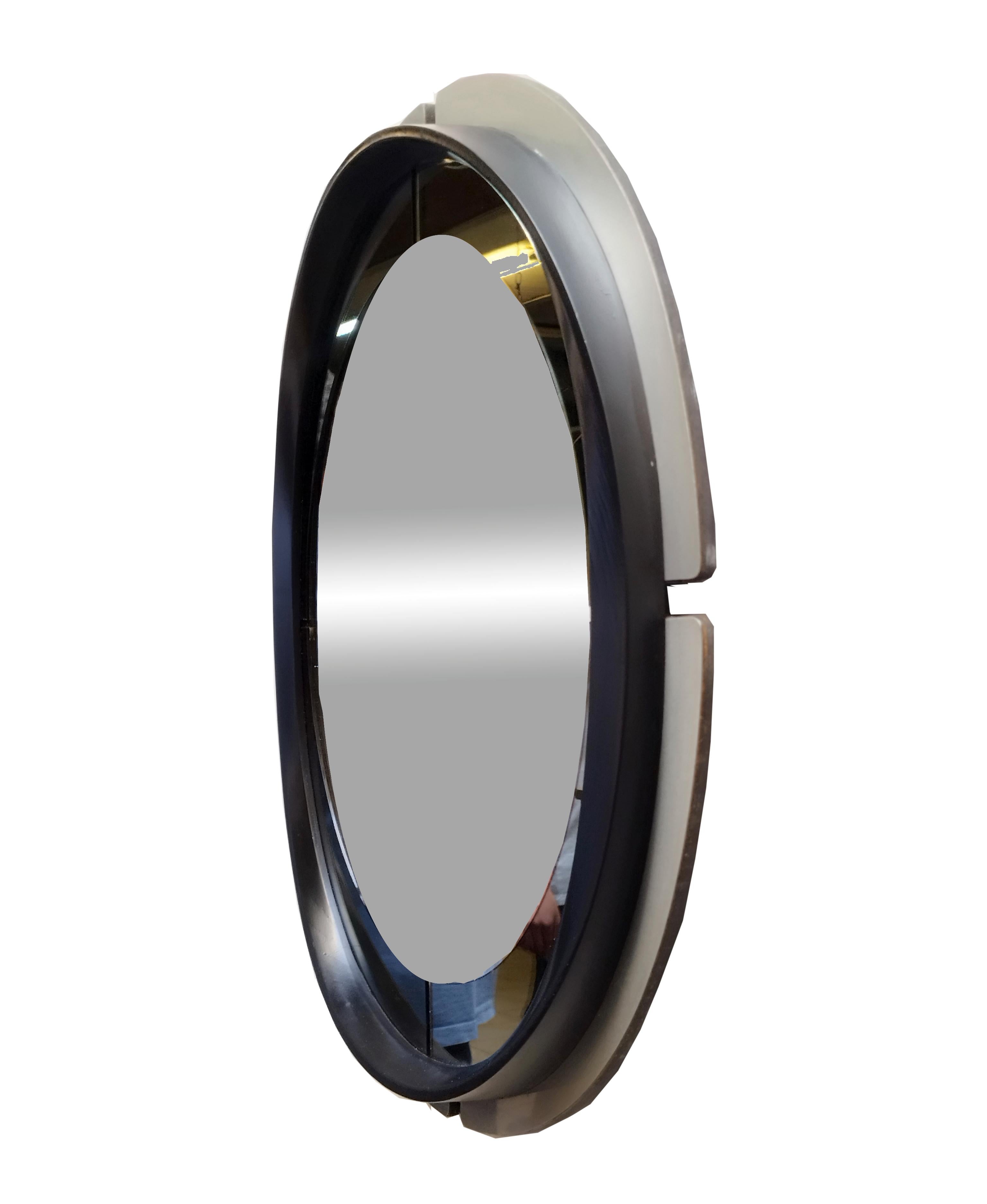 Round wall mirror with brushed metal frame and black lacquered finish, 1970s. Very good preserved condition slight and obvious signs of time due to use and age.