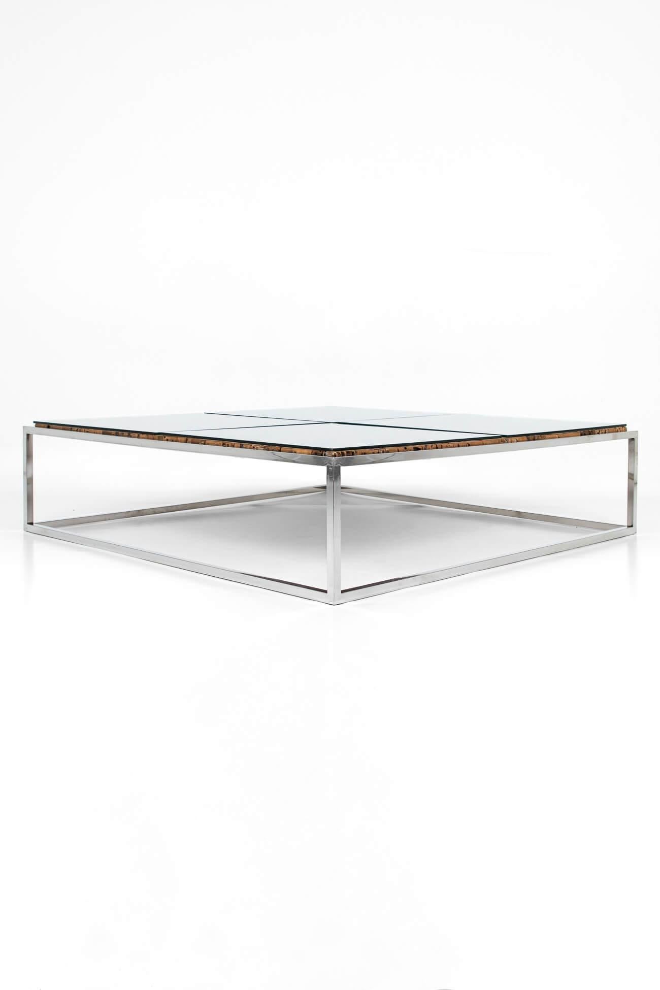 Stunning square chrome and wooden cork effect low centre table. The gleaming chrome frame divides the rich wooden cork effect top into four sections and on top of each section sits a sheet of clear tempered glass. With incredible lines and a