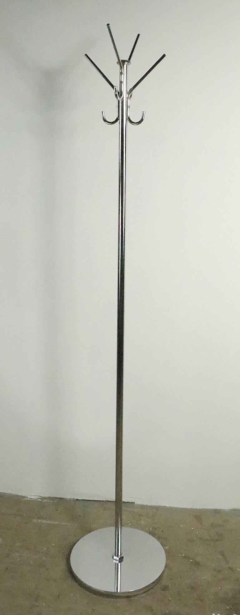 Nice bright chrome Machine Age, Art Deco coat tree having four arms each with two hooks, one for your coat, one for your hat, scarf etc. The stand is well made, constructed to commercial standards, clean and ready to use. Dia. of base 14 x W at top