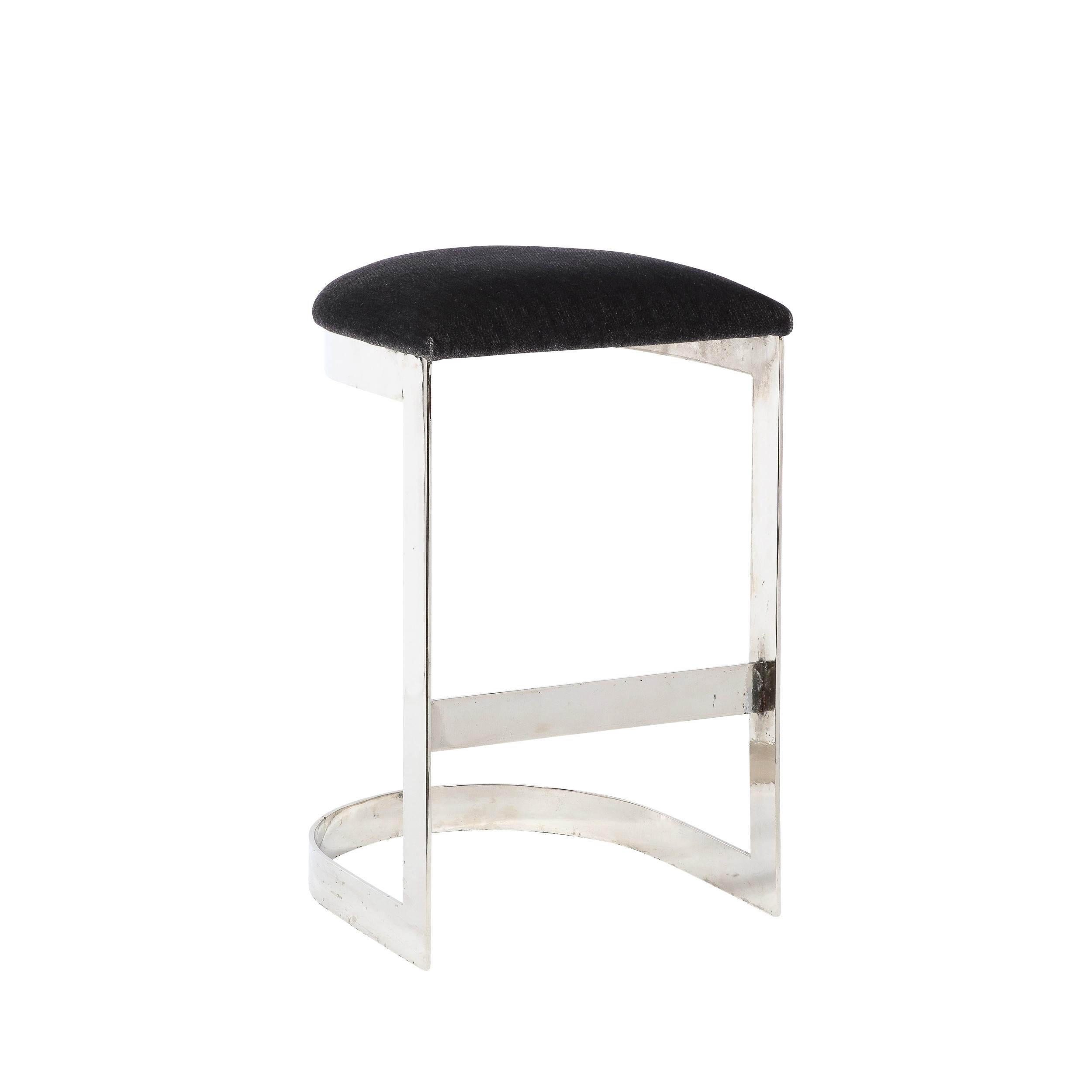 This stunning pair of Mid Century Modern bar stools were realized in the United States during the latter half of the 20th century. Designed in the manner of Milo Baughman- one of the most interesting and influential practitioners of late modernist