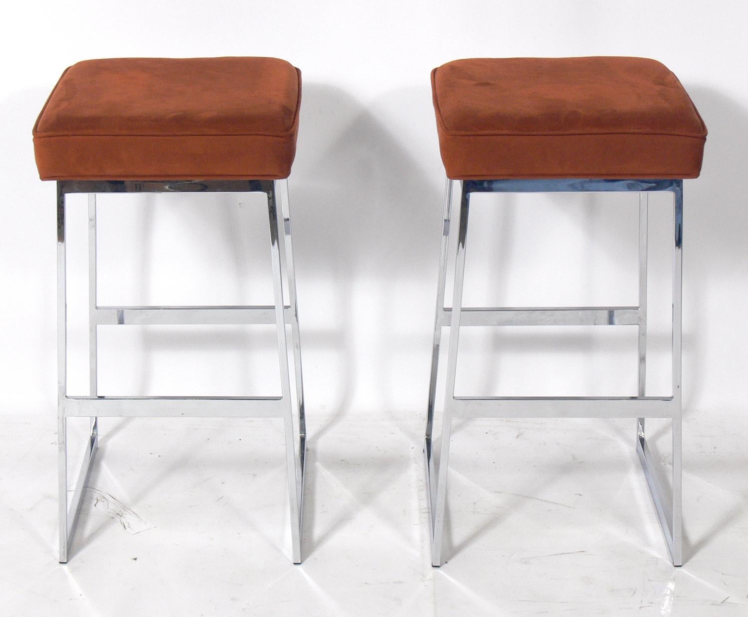 Chrome bar stools in the style of Milo Baughman, American, circa 1960s. They are currently being reupholstered and can be completed in your fabric. The price noted includes reupholstery in your fabric. Simply send us four yards total of your fabric