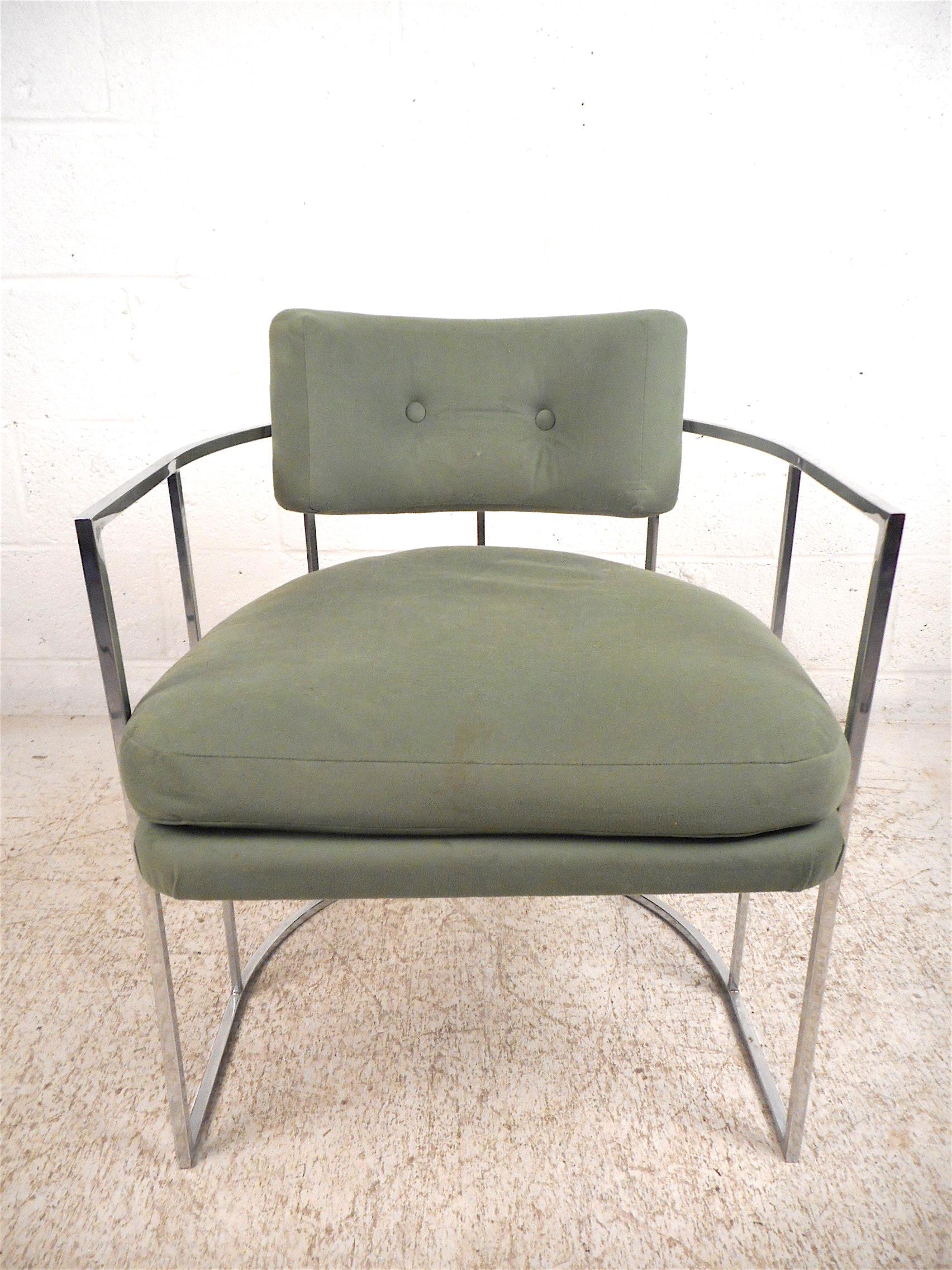 Stylish set of 4 barrel back dining chairs designed by Milo Baughman. Sturdy and sleek chrome frame which supports seat and backrest cushions that are covered in a vintage green upholstery. A great set sure to make an impression in any modern
