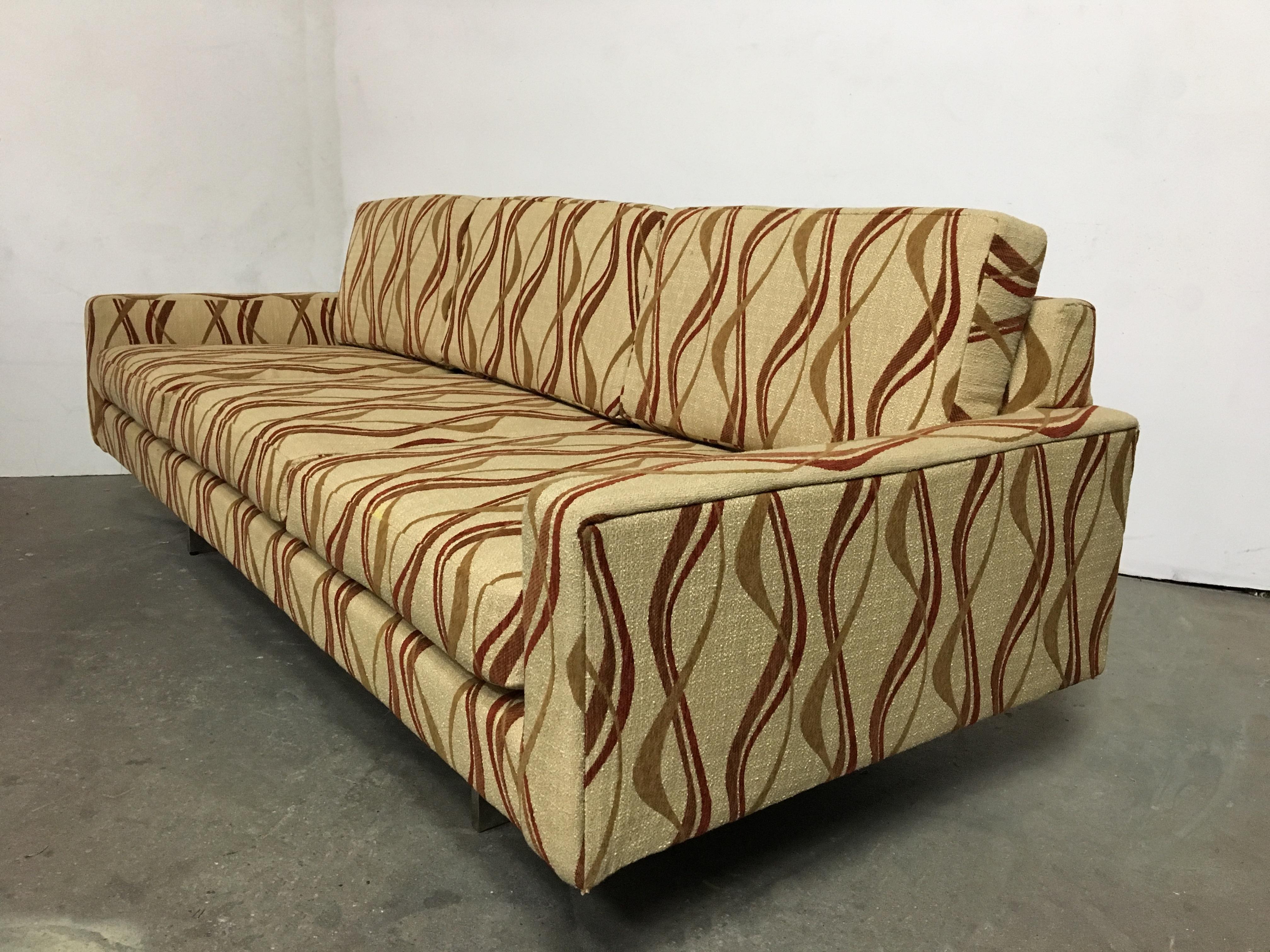 Chrome base 1970s Tuxedo sofa reupholstered in the manner of Milo Baughman reupholstered in a playful fabric.