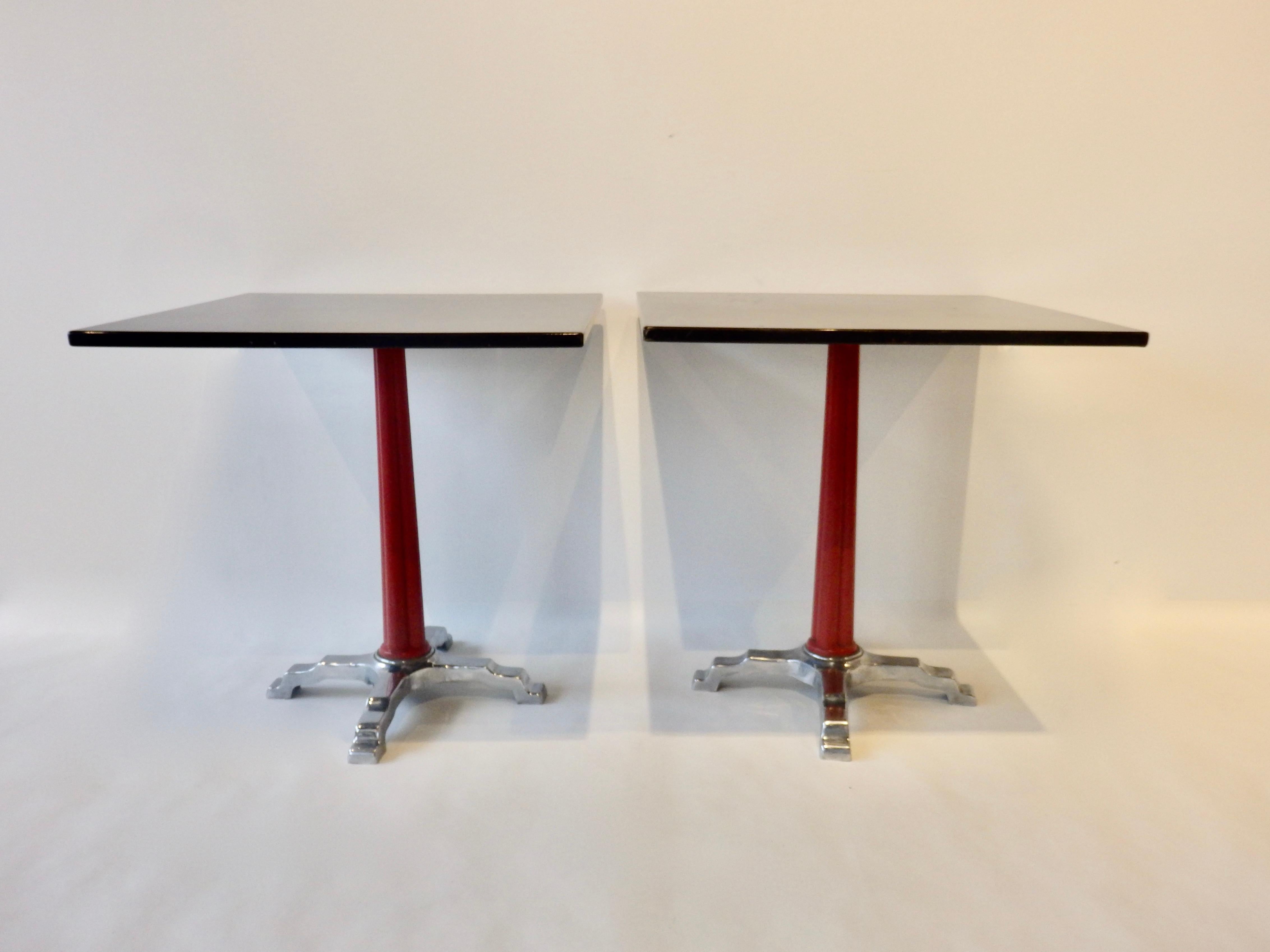 Four Art Moderne or Deco bistro dinette tables. Chrome cast iron base with lacquered column supports square black lacquered tops. Top surfaces show wear. Chrome shows age and patina. Not rusted. Priced individually.