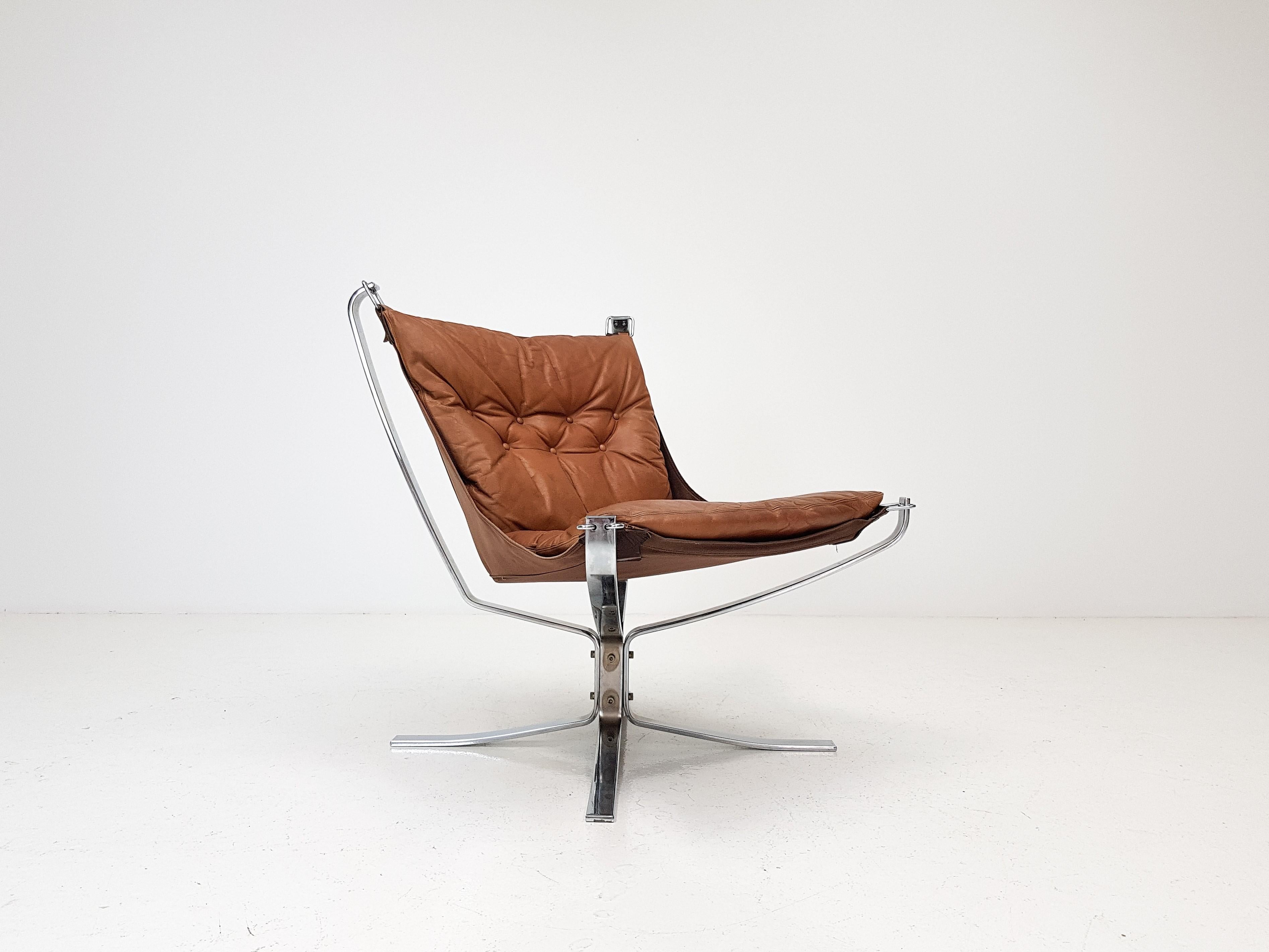 Iconic vintage low-backed X framed Sigurd Ressell designed, 1970s Falcon chair on chrome-plated steel base with cognac leather.

A super comfortable, amazing looking, 1970s Sigurd Ressell designed iconic Falcon chair. X framed with hammock design.