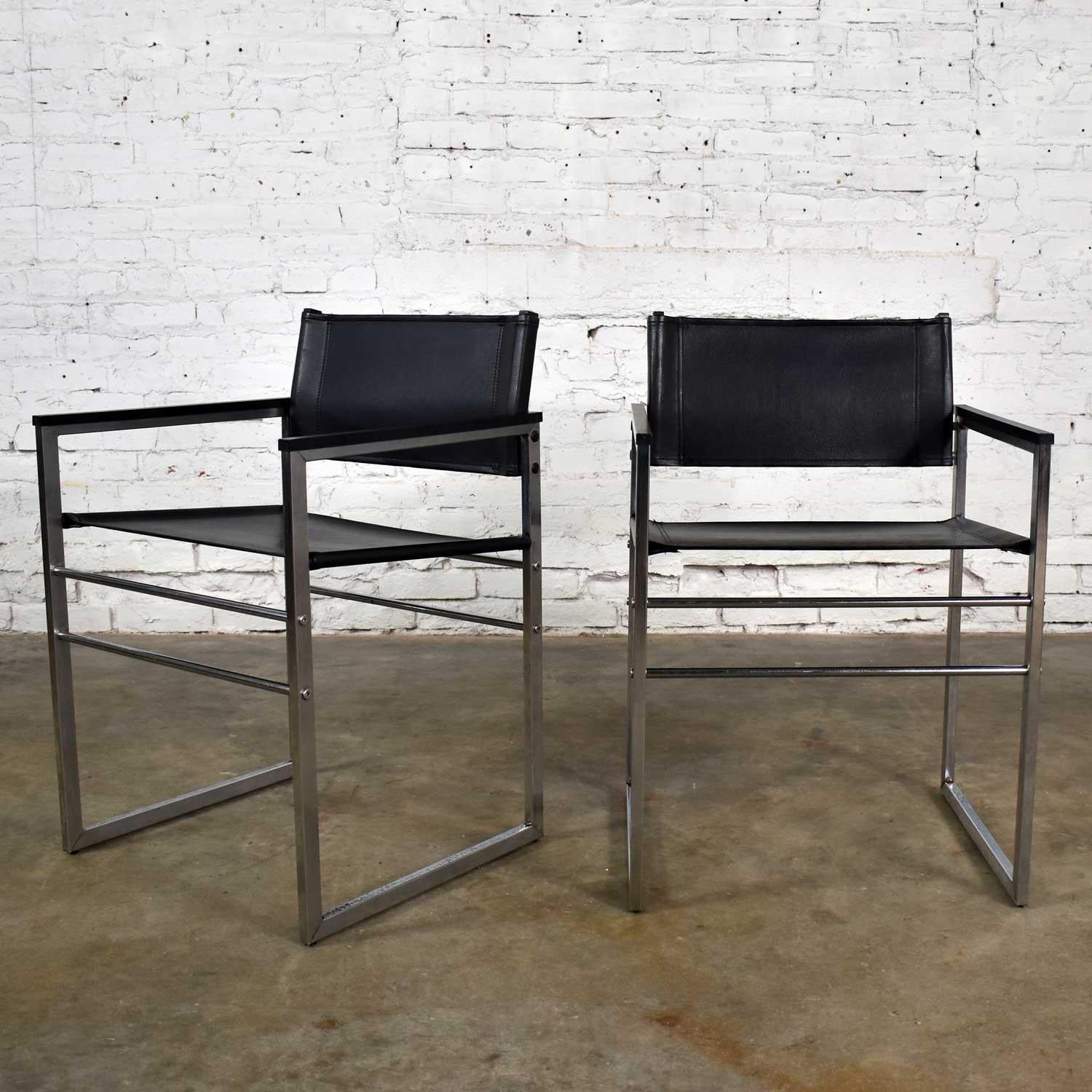 Handsome pair of chrome and black vinyl faux leather Campaign style sling director’s chairs with straight legs. They are in wonderful vintage condition. They wear their original black faux leather slings which look great. The chrome has been cleaned