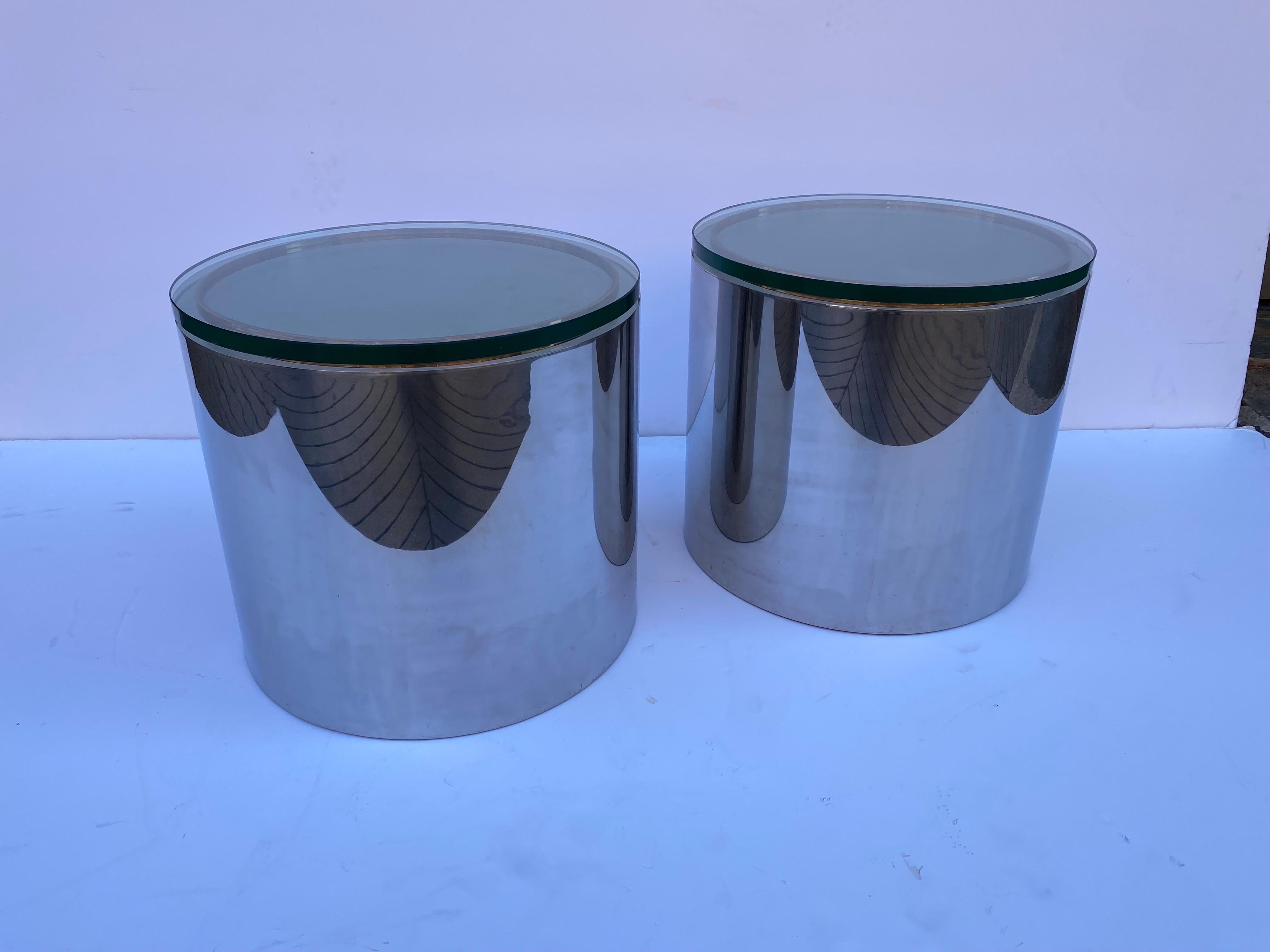 Pair of chrome drum tables with a brass ring. Glass sits slightly elevated from the chrome drum. Simple elegant design! Perfect to use in many ways!