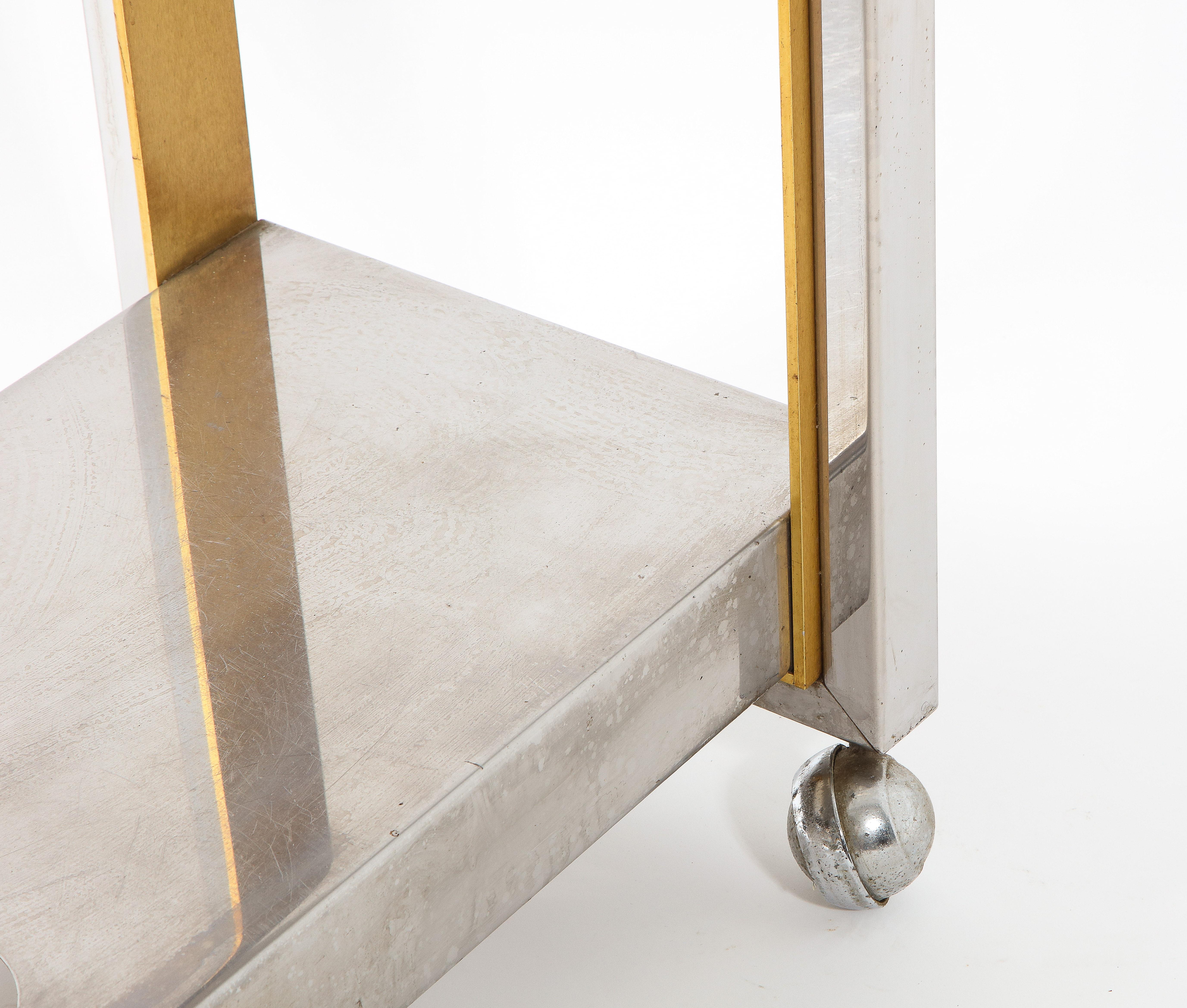 Elegant bar cart in chromed steel and brass.