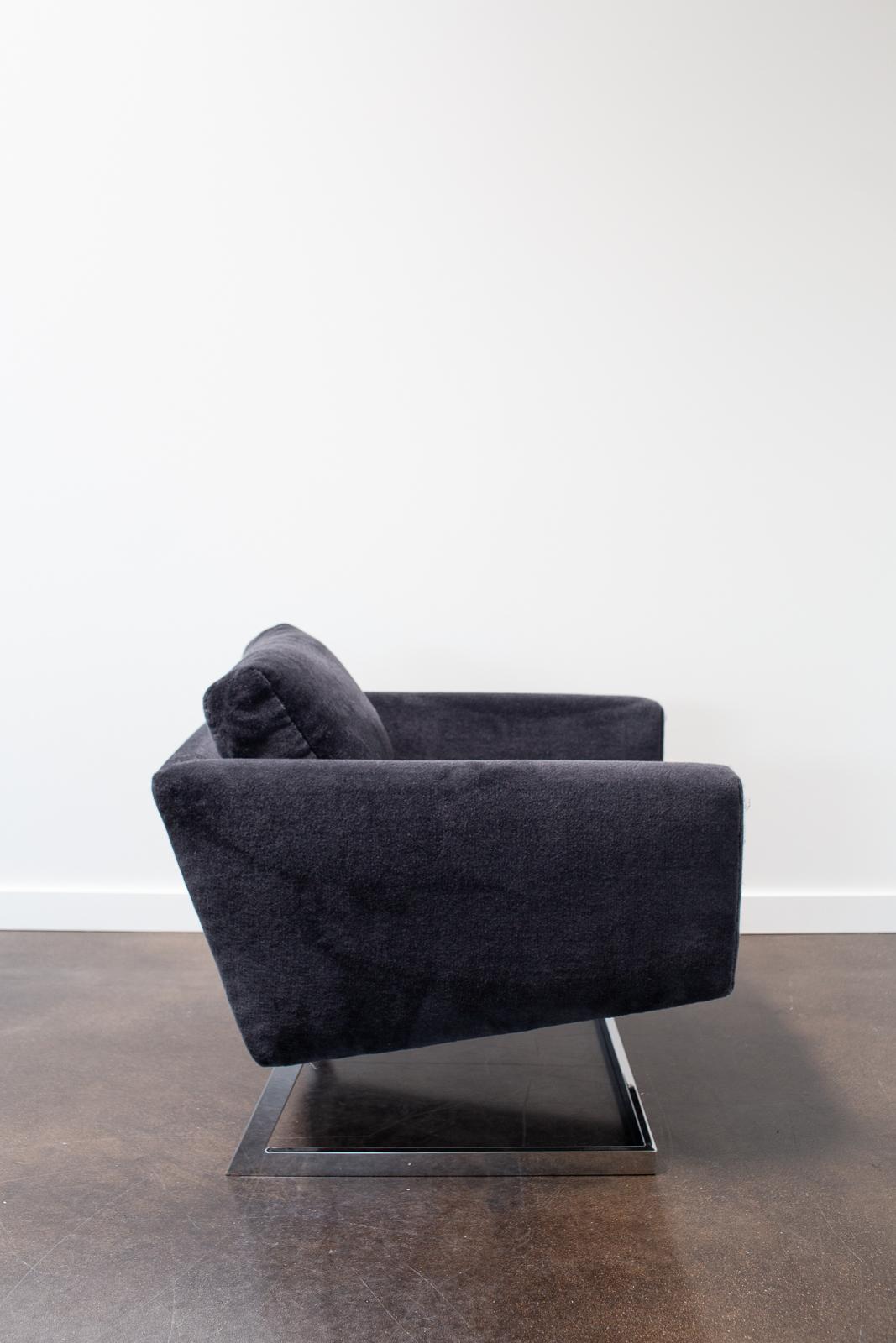 A Chrome Cantilever Lounge chair has been reupholstered in a deep blue/gray Fox Linton wool complementing the chairs masculine shape. The cantilevered chrome base has been professionally refinished by the Selby House.