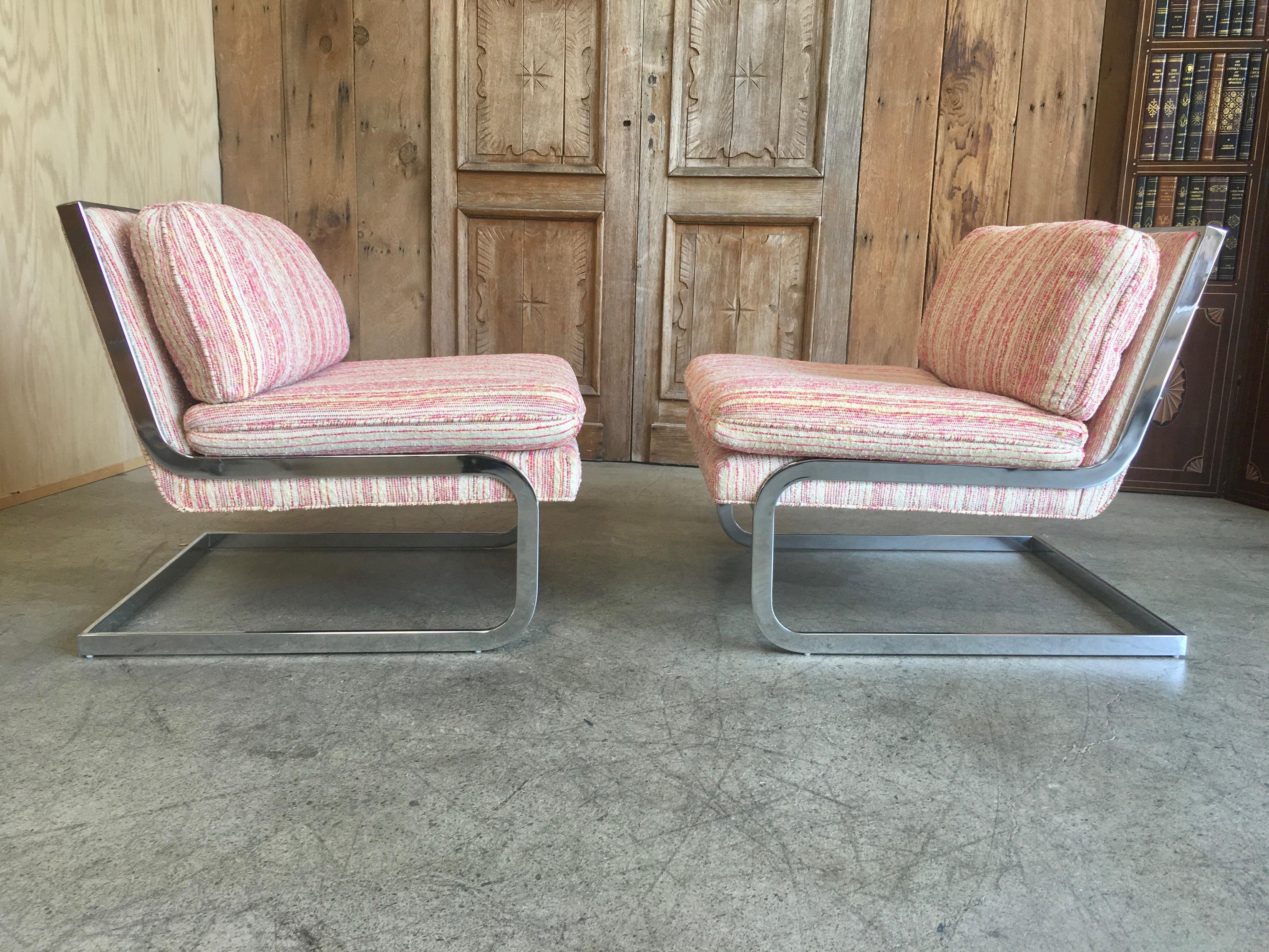 Pair of chrome cantilevered lounge chairs in the style of Milo Baughman 
These have been professionally cleaned, but new fabric might be preferred.