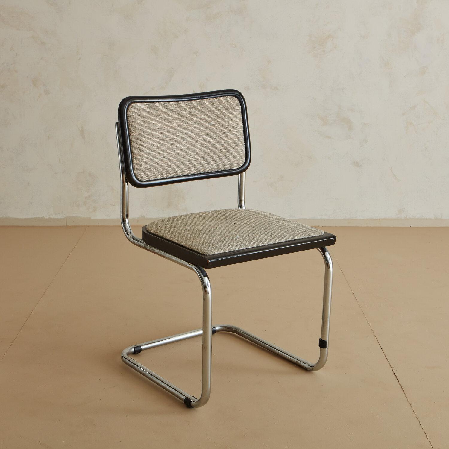 A simple, stylish and utilitarian mid-century desk chair reminiscent of Marcel Breuer’s iconic Cesca chair designed in 1928. This chair features a tubular chrome frame, black lacquered wood and original upholstery.