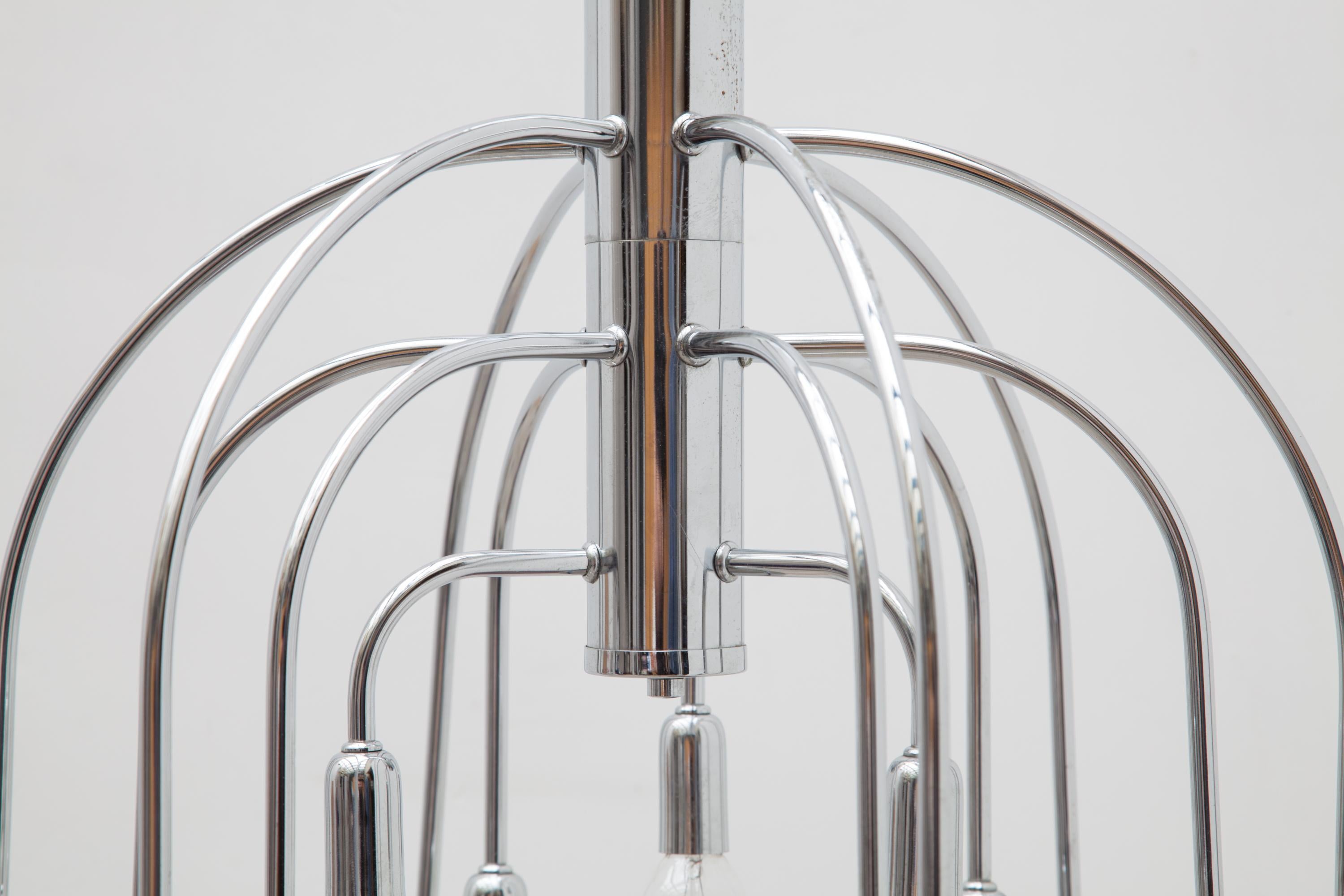 Shiny 1970s chrome tube chandelier by Gaetano Sciolari lit by fifteen bulbs designed as enlightened descending raindrops executed by Boulanger Belgium.
Mint condition.
  