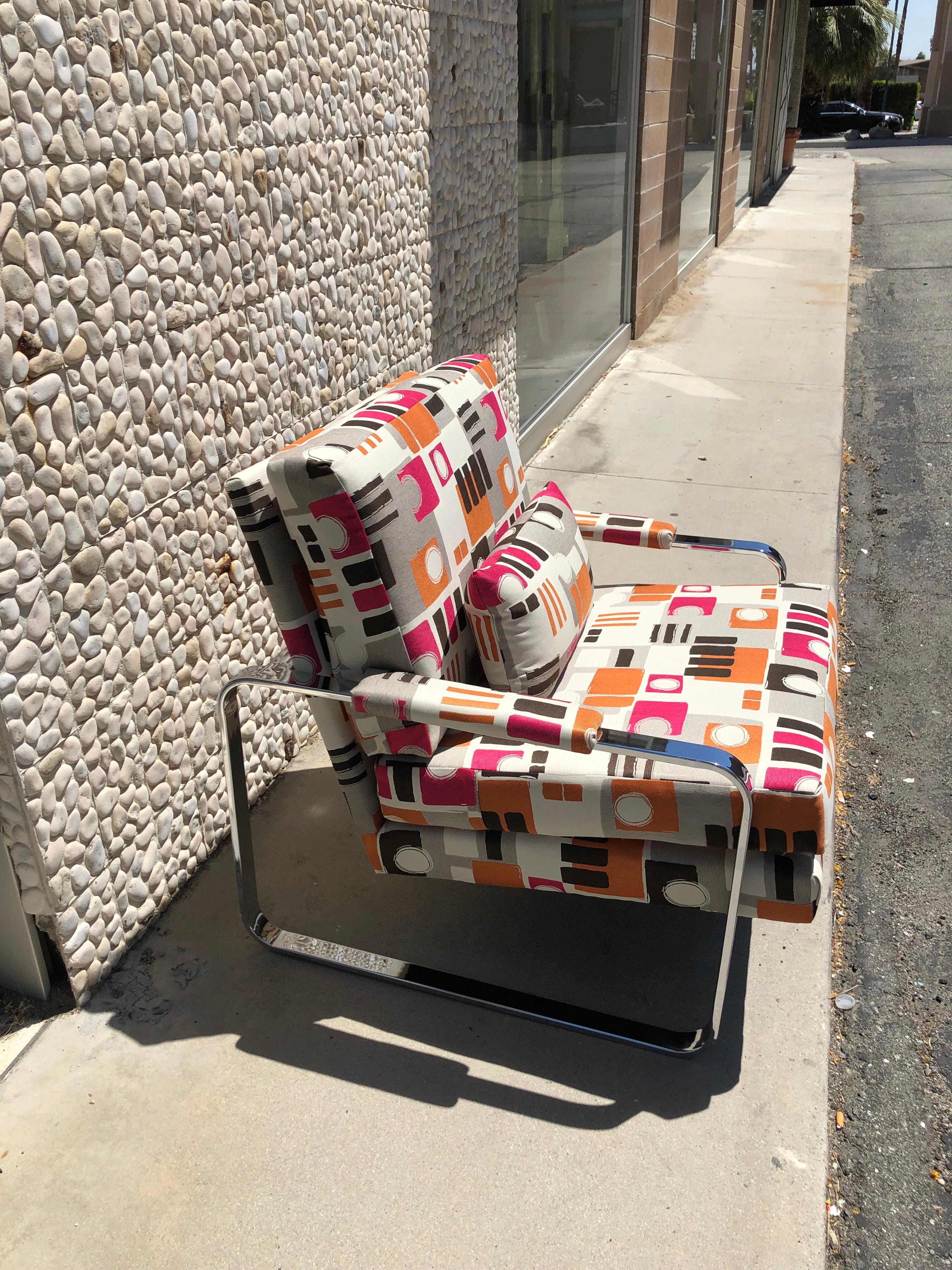 This modern chrome club chair was made in the 1970s. In the style of the iconic Milo Baughman chrome armchair. The chair has been redone in a very high end modern art jacquard fabric. A beautiful modern art chair.