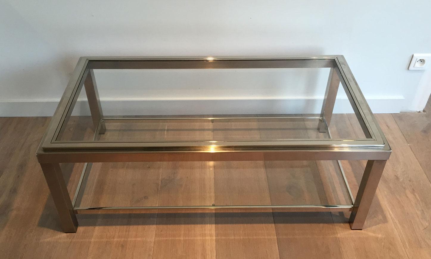 This coffee table is made of chrome with two glass shleved. The top glass shelves is inserted in a chrome frame. This is a French work of very nice quality, circa 1970.
