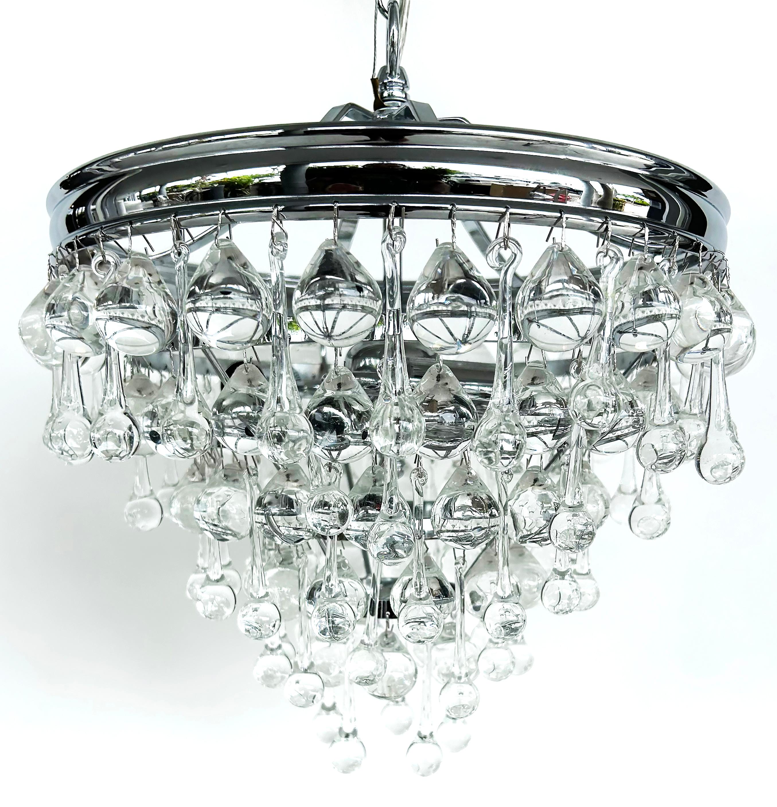 Dense Crystal Teardrop Chrome Pendant 3-Light Fixture, Chain and Canopy

Offered for sale is a very dense modern chrome light fixture with large crystal tear drops hung in several levels. The fixture has 3 lights that accept standard bulbs. The