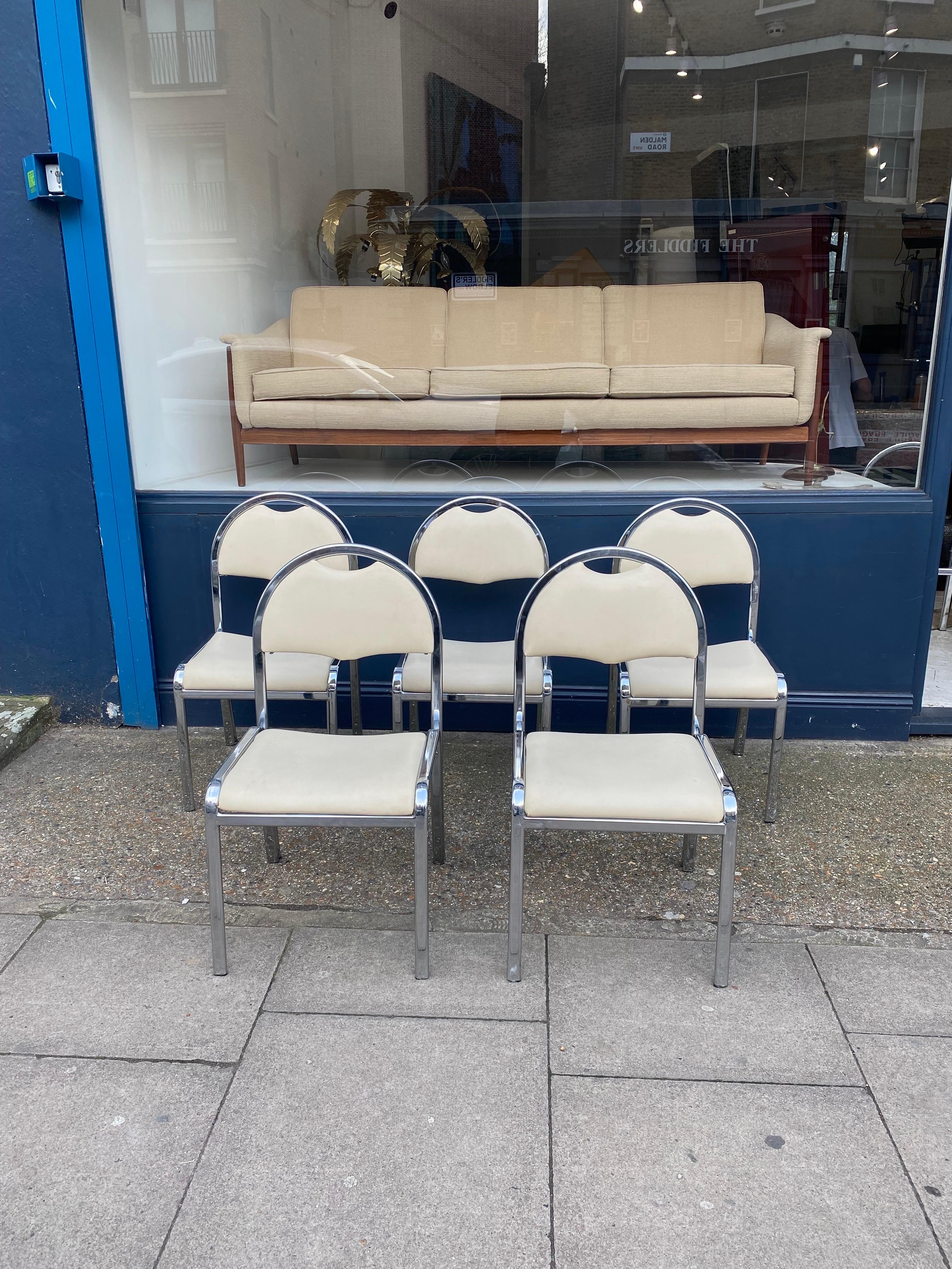 Italian chrome set of five dining chairs in beige leatherette. Double layered chrome curved tube frames with arched back with nicely designed pull on the top of the back rest. The leatherette is overall in good condition with some light signs of