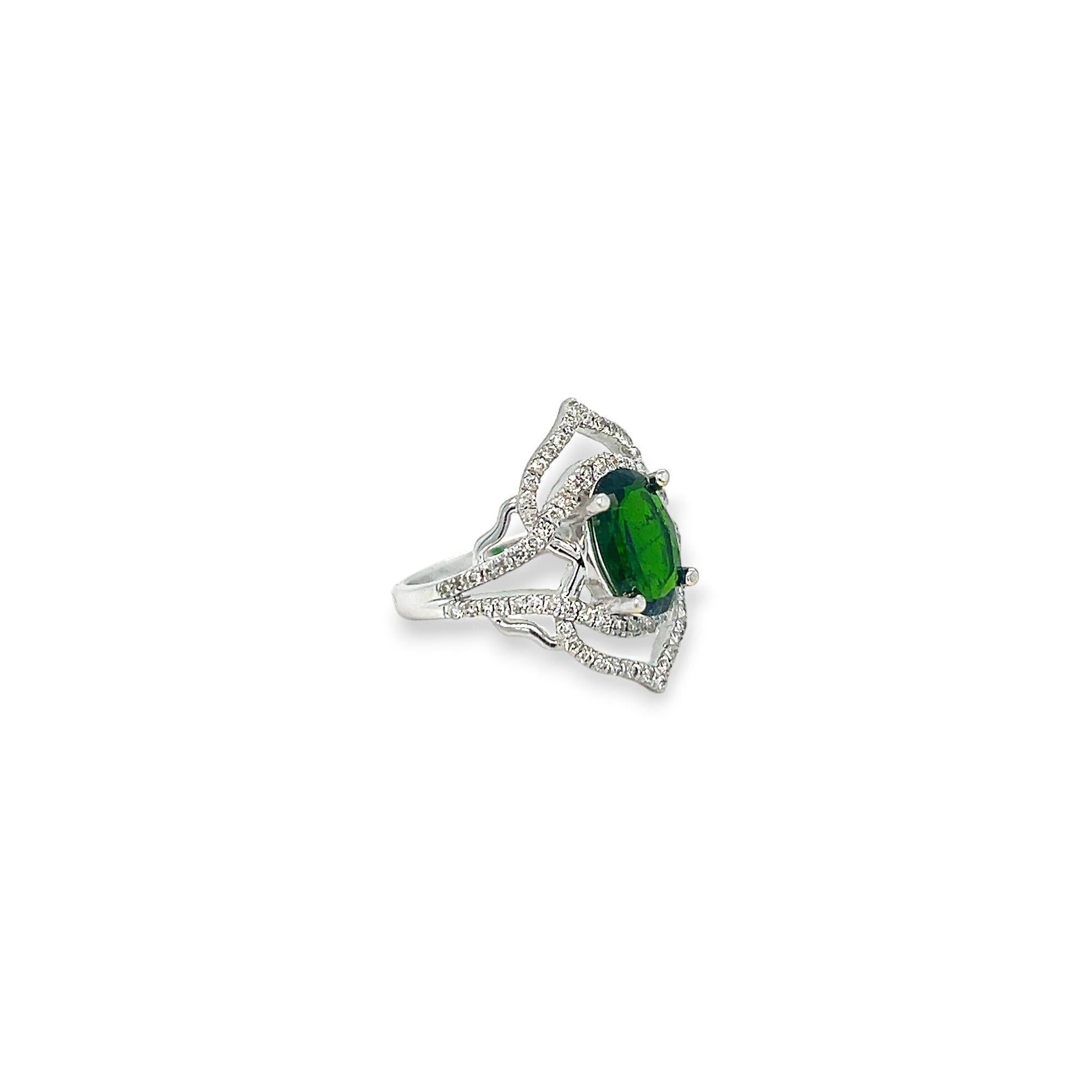This stunning statement ring features a 1.59 ct oval chrome diopside center stone. This 14k white gold ring also has round side diamonds of 0.41 total cts, H/I color, and SI clarity. 