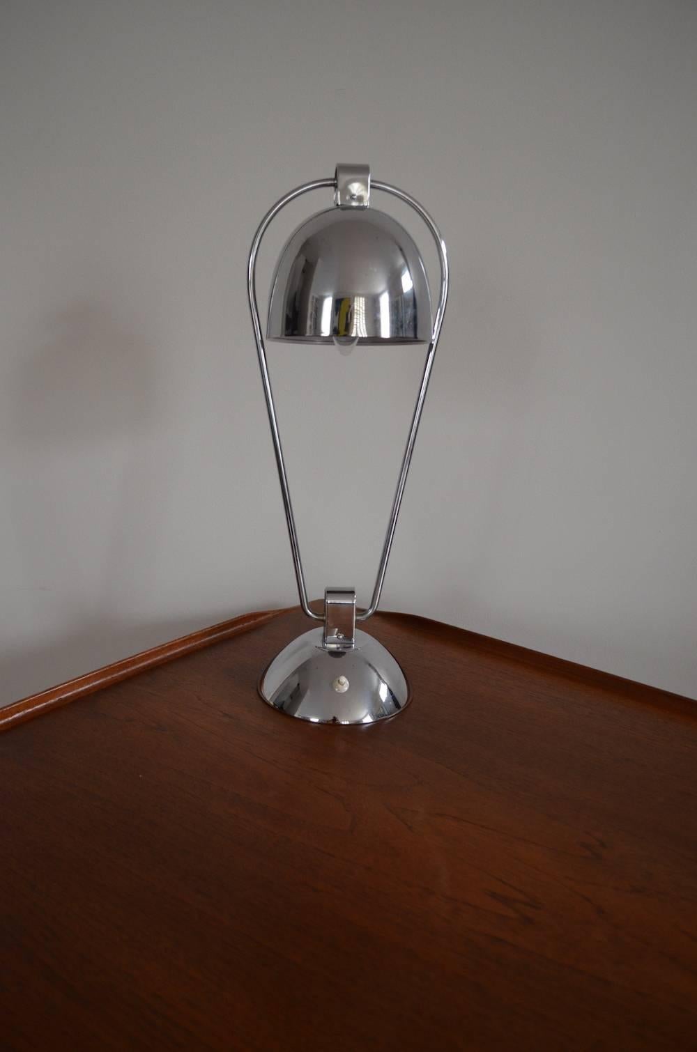 A 1950s chrome table desk lamp with domed shade and base.
 