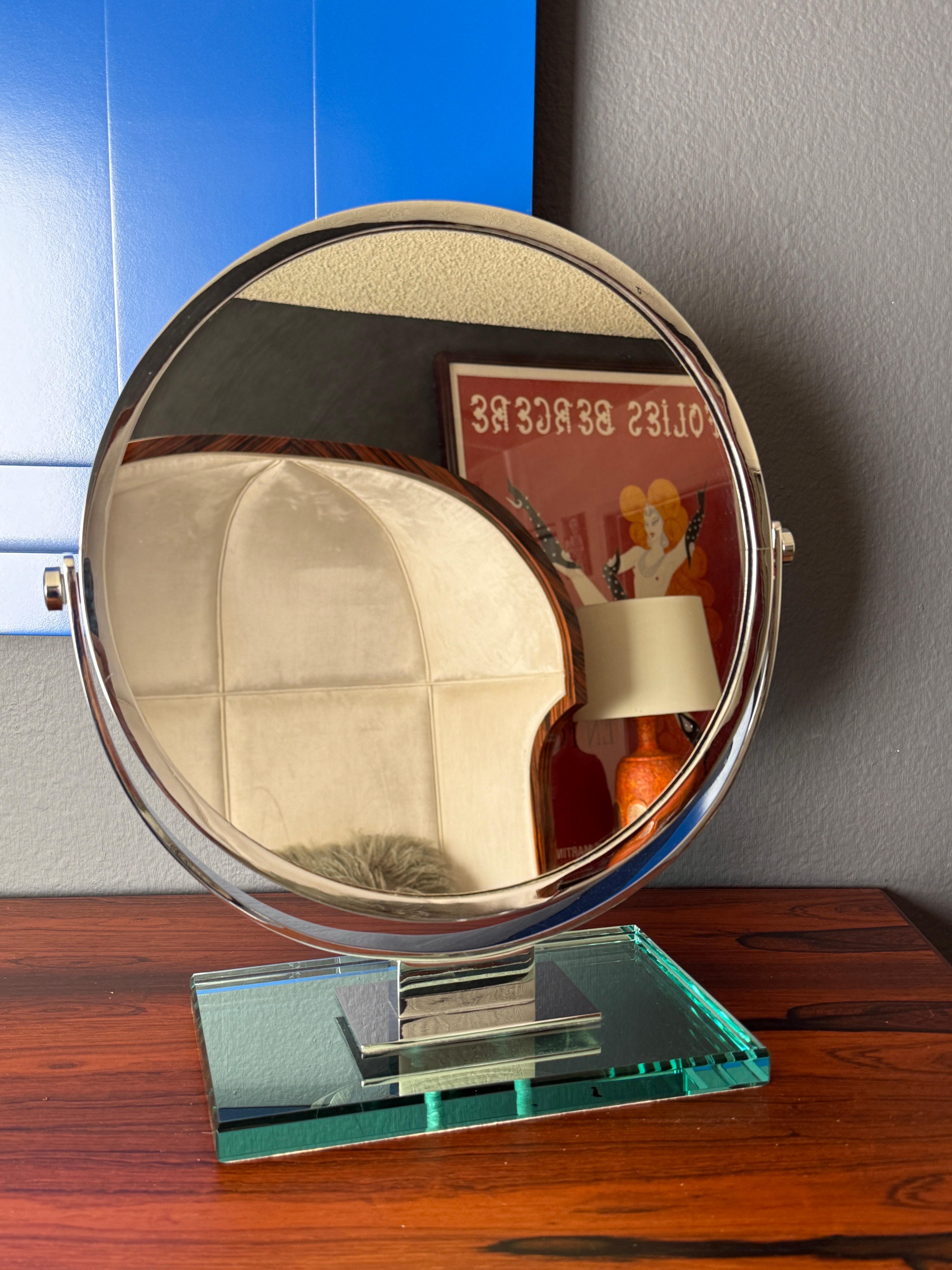 Chrome tilting double sided mirror with magnifying mirror on the other side mounted on glass base in the style of Karl Springer or Charles Hollis Jones. Only mirror is 13