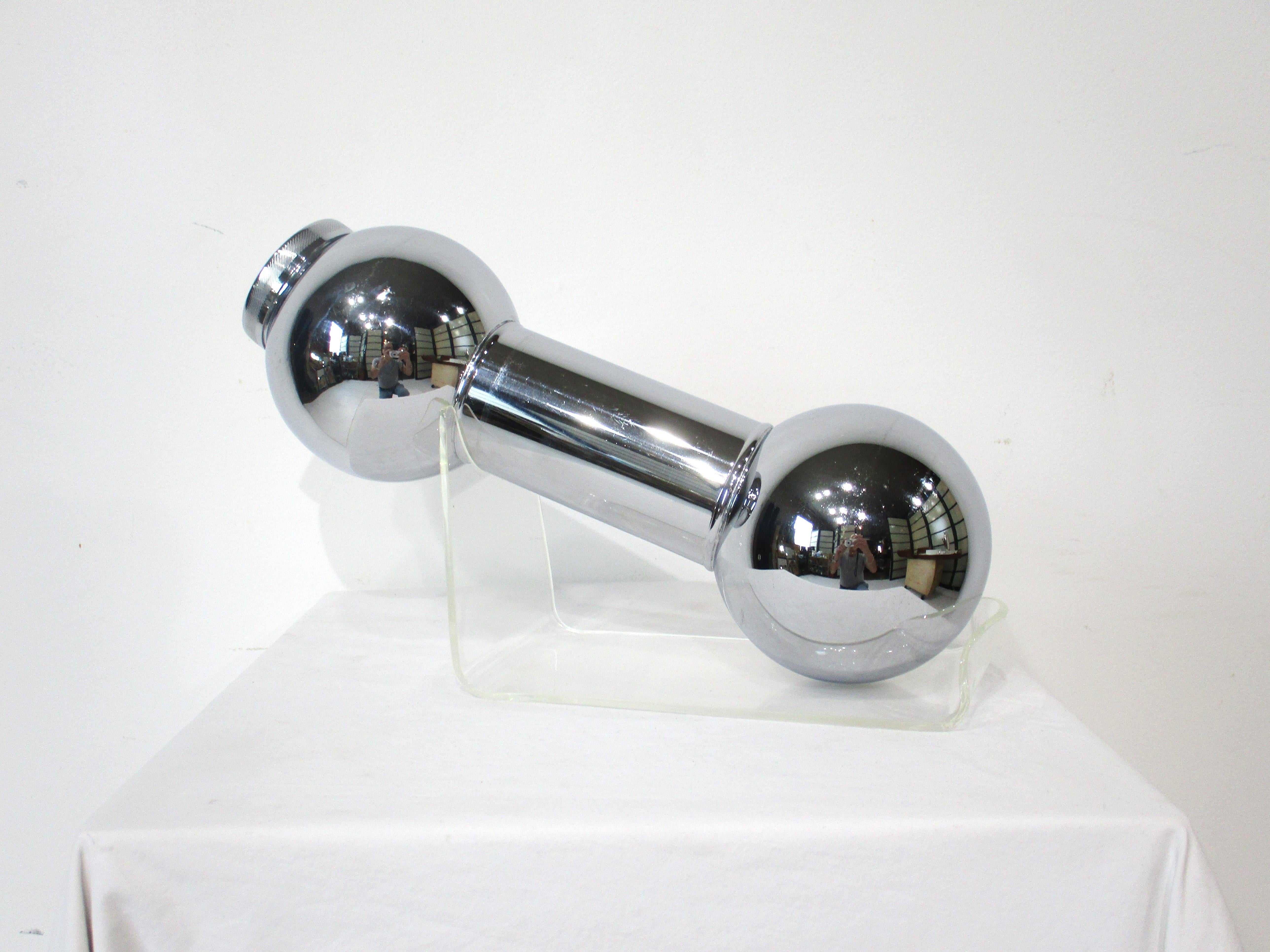 A classic chromed metal dumb bell cocktail shaker with the lid to one end having a removable strainer . Great for that party , bar display or just making a cool refreshing drink , manufactured in the manner of the Meriden Silverplate company , the
