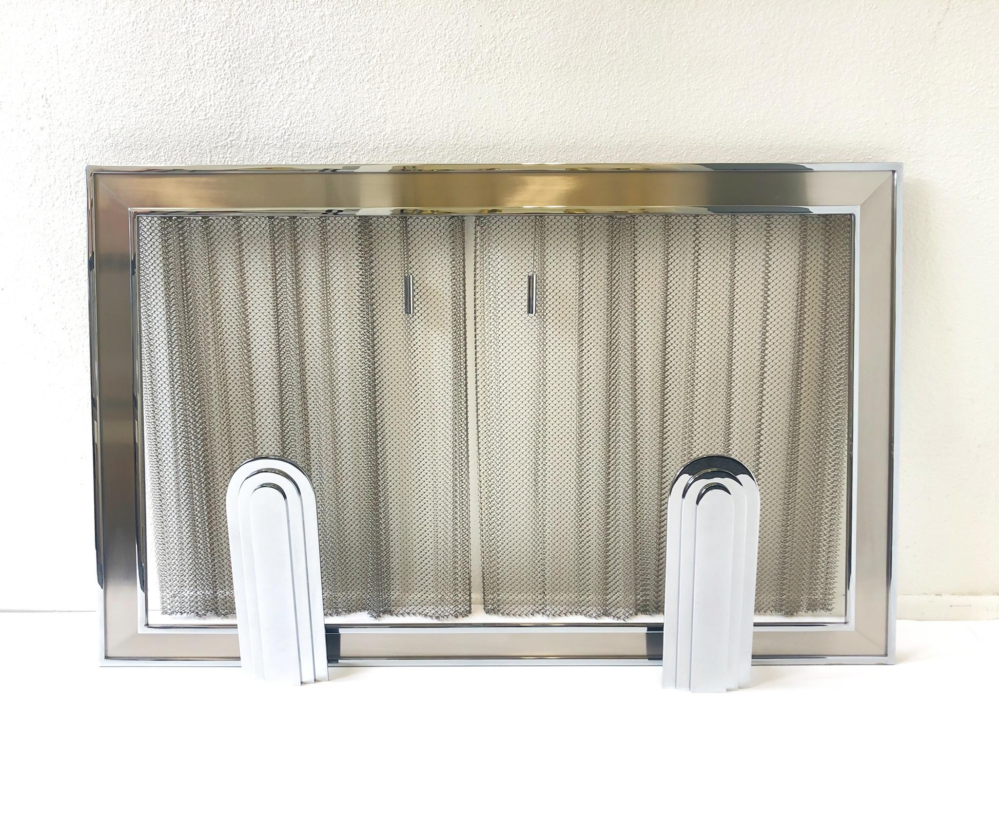 A rare polish chrome French fireplace set designed by Maison Charles in the 1970s.
The set consists of fireplace tool set, andirons, gas key and fireplace screen. The fireplace screen is polish and brushed chrome. The fireplace tools, andirons and