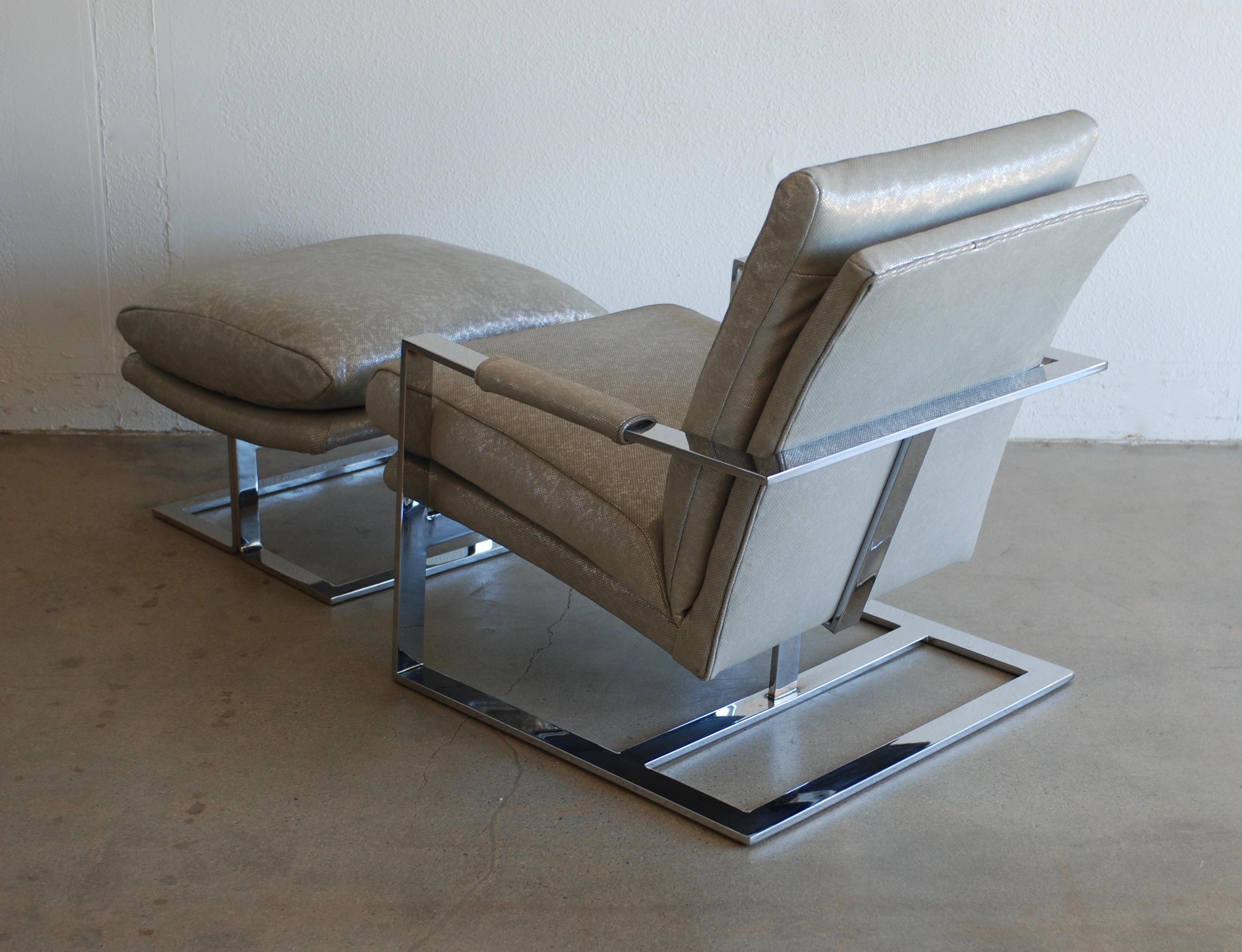 This vintage 1970s Milo Baughman style lounge chair and ottoman has been recovered
in a buttery soft silver metallic Edelman leather. The leather is embossed with a circular pattern and has an opalescent quality to it. The chrome flat bar frame is