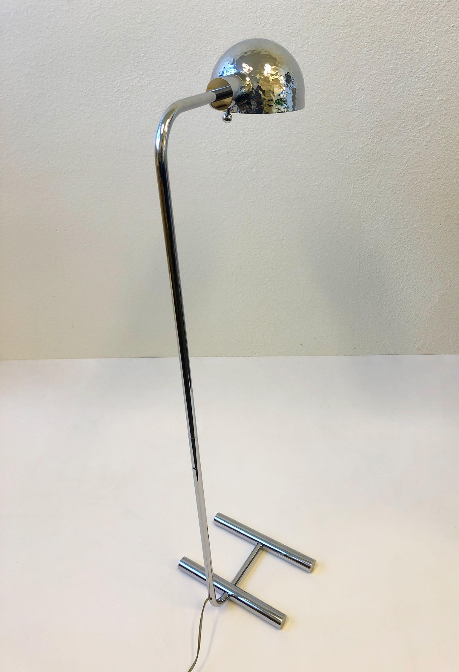 A glamorous polish chrome floor lamp designed in the 1980s by Boyd Lighting Company. The lamp has been newly rewired with a full range control dimmer. The lamp is constructed of solid brass that is chrome painted, the shade is hammered. The lamp