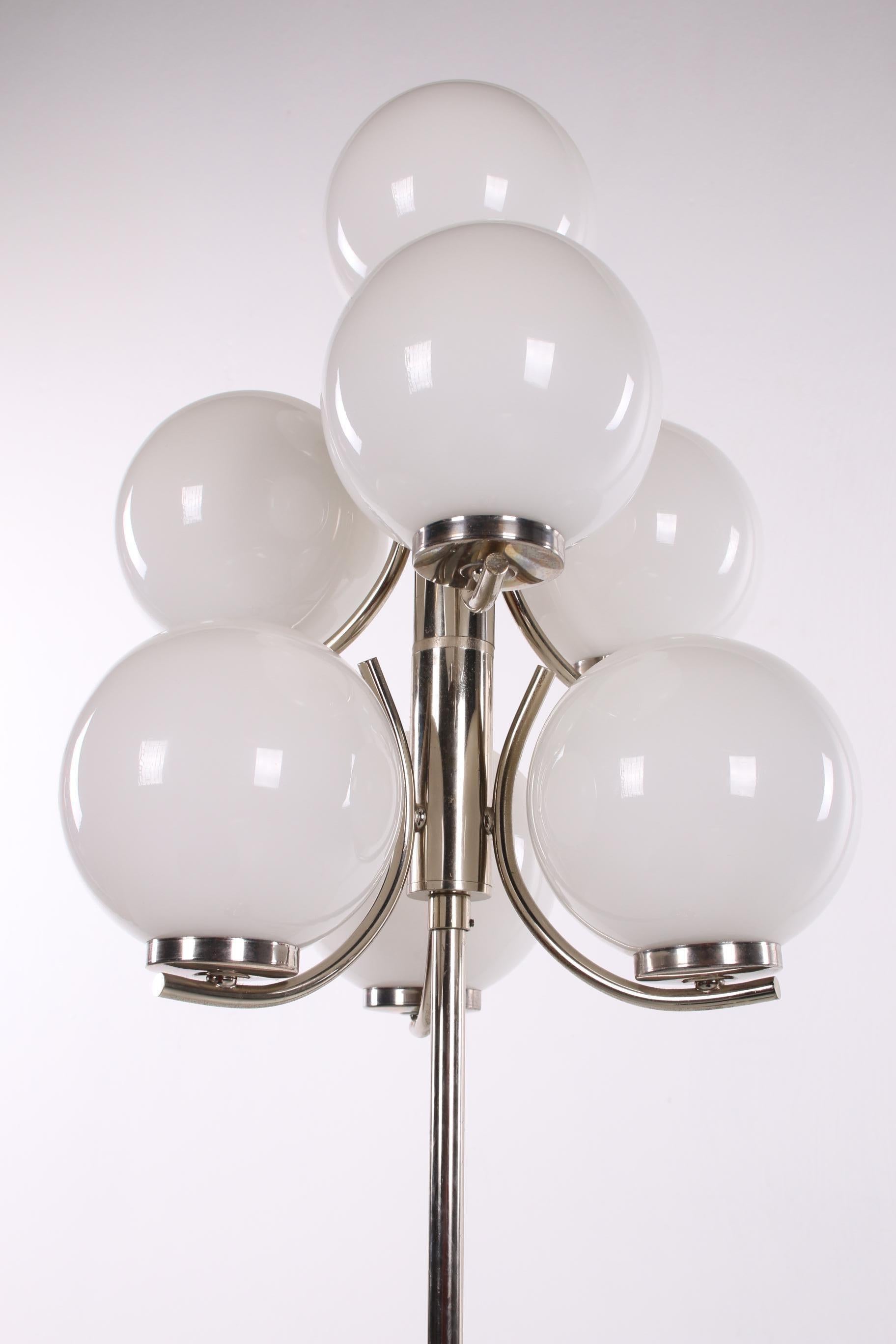 Vintage designer floor lamp estimated to be from Germany in the 1960s. 

The lamp has a chrome base with beautiful ornate chrome details. This lamp also has 7 beautiful glass balls that spread a warm ambient light. 
The lamp is in perfect
