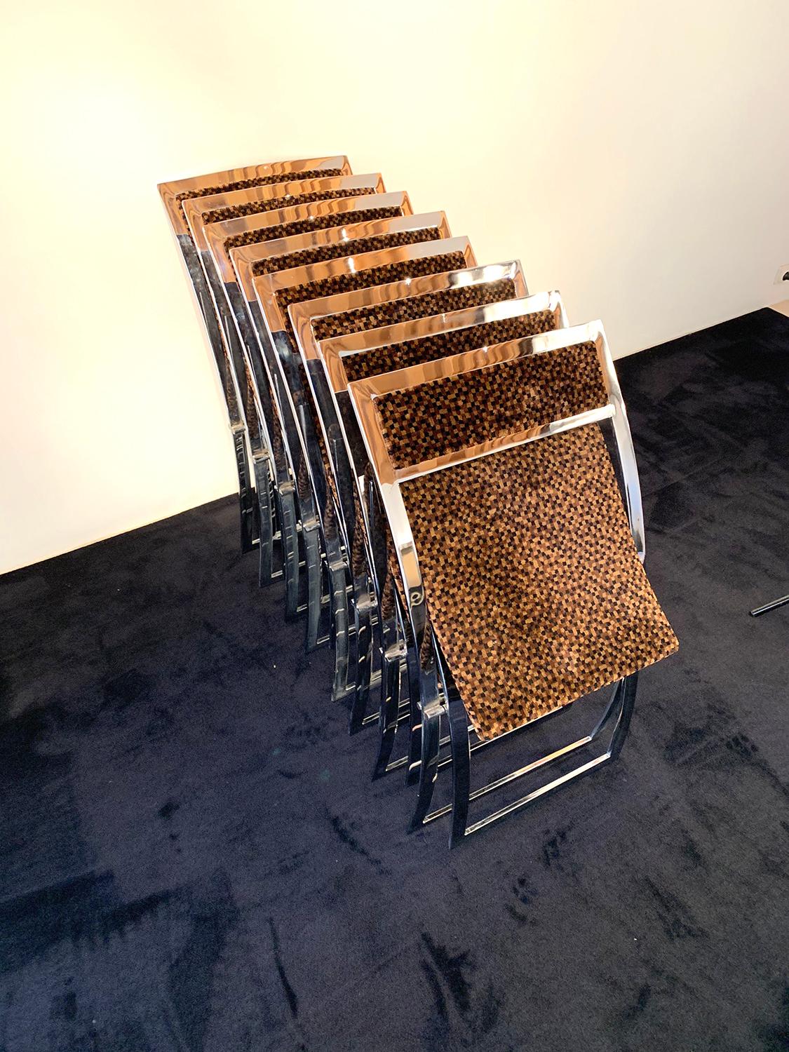 Superb set of folding chairs designed by Marcello Cuneo in 1970 and produced by Mobel. The frame of the chairs is chrome-plated and the seat and back are covered with the original fabric, a velvet in brown tones of high quality.

The chairs are
