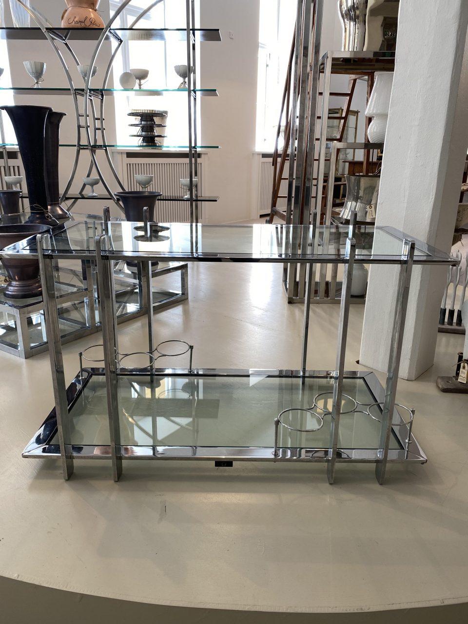 Handsome vintage French counter / bar / side table, with glass shelves. Formed in the 1960s-1970s, with a definite nod reference to the metal and strong gorgeous designs of the Art Deco era in the 1930s. Fun stylish bottle holders on the lower