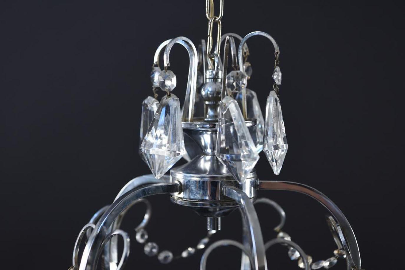 Small Postmodern chandelier with five lights with crystal swags, faceted as well as ball drops with chrome caps. Can be perfect for small entry foyer, powder room. As is condition.
OFFERING FREE SHIPPING WITHIN US CONTINENT.  PLEASE JUST ASK FOR A