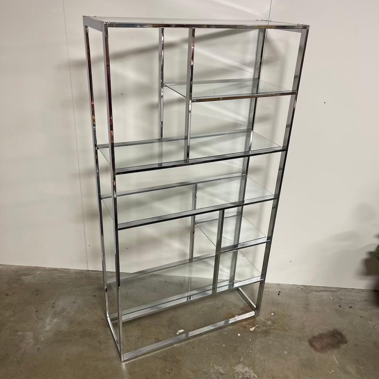 Nice mid century chrome and glass shelf in the manner or Milo Baughman. Great shape piece. Chrome and glass in great shape. (missing the very bottom section of glass that rests upon the ground) Not very noticeable when positioned. Looks great with
