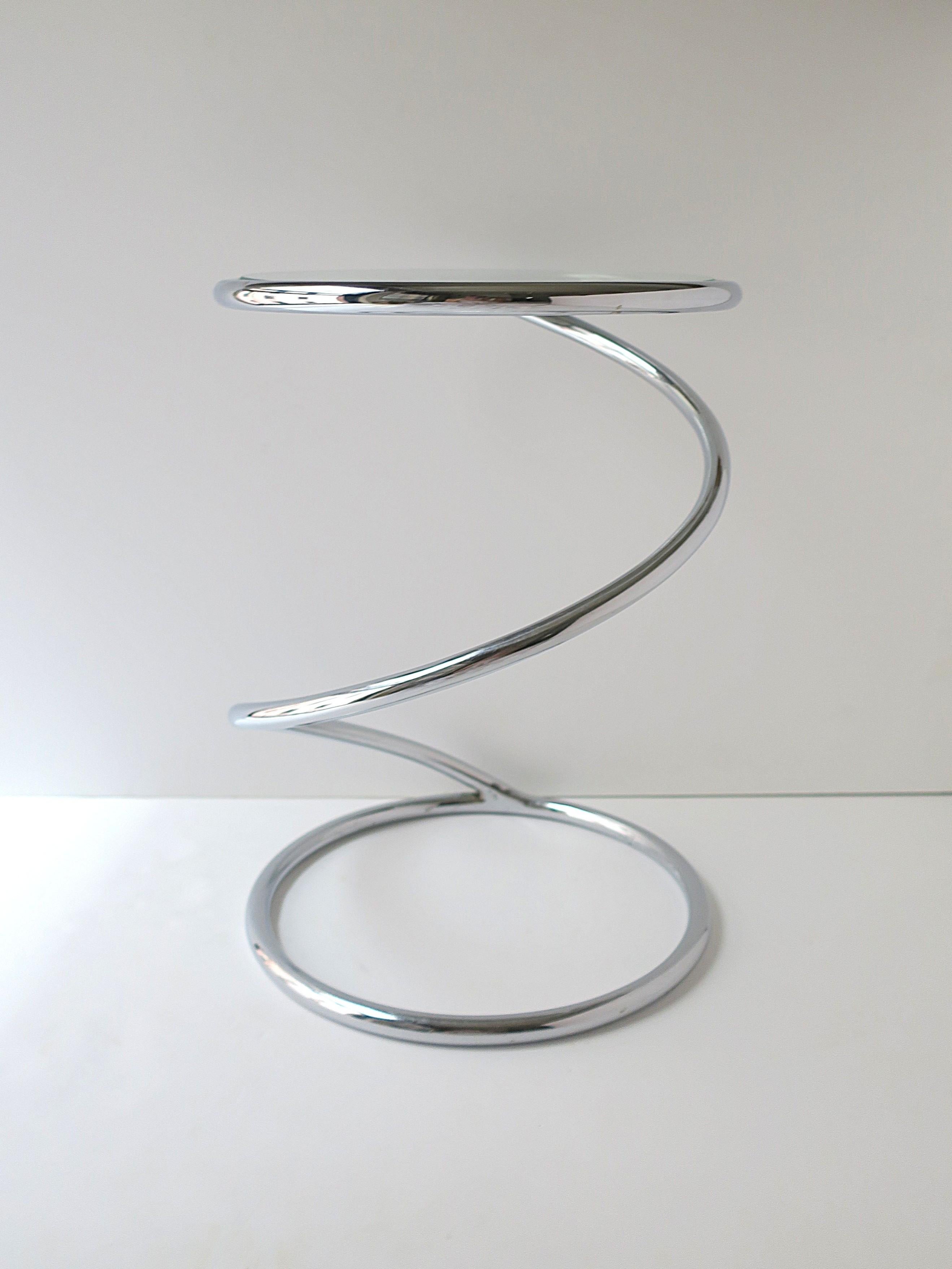 A substantial, well-made, designer round chrome and glass twist side/drinks table, between Midcentury Modern and Postmodern design periods, from the Pace Collection by Leon Rosen, New York, NY, circa mid to late-20th century, 1960s, 1970s. From a