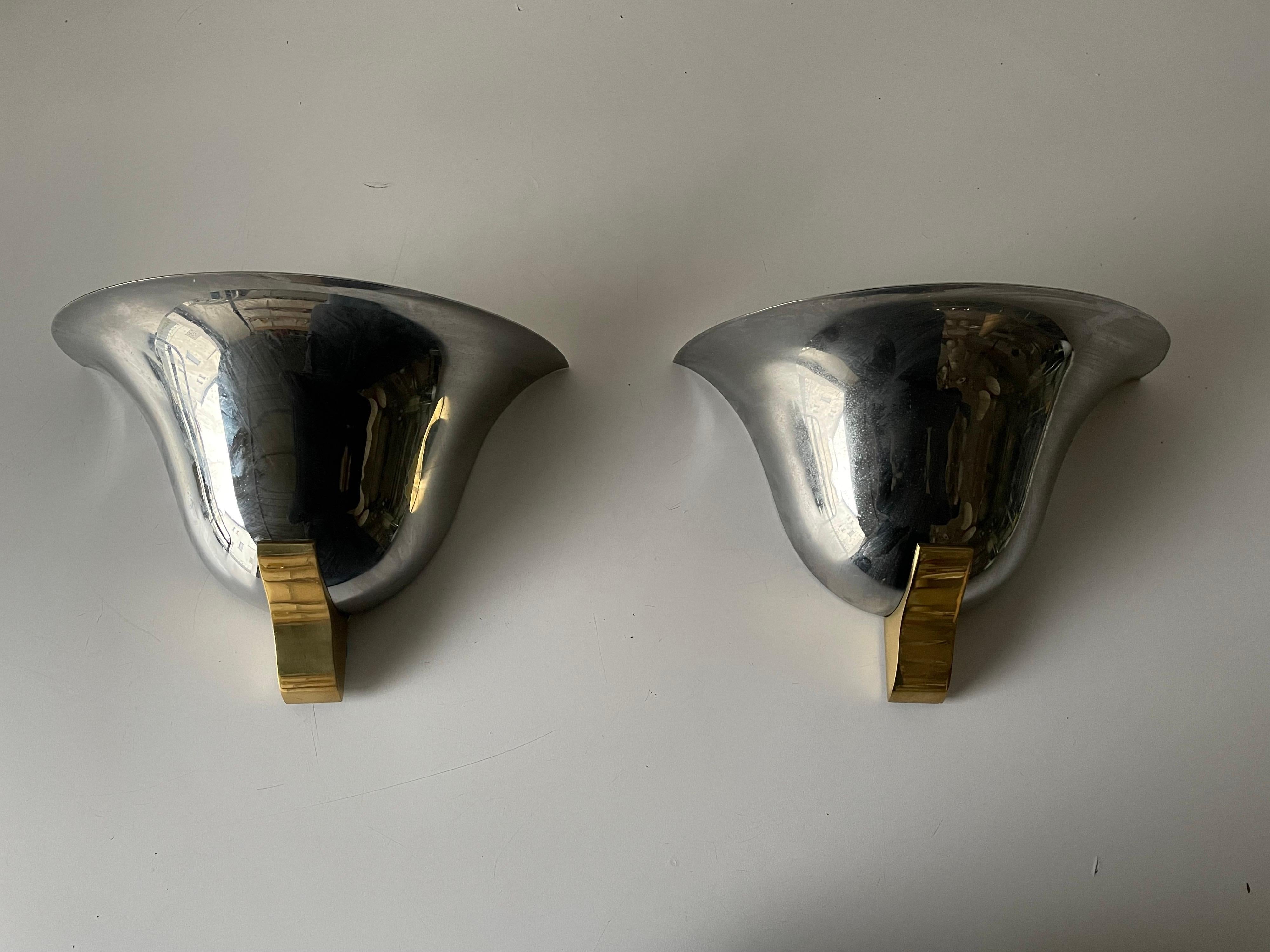 Chrome & gold metal pair of sconces by Art-Line, 1980s Germany

Very elegant and Minimalist sconces

Lamps are in very good condition.

These lamps works with E27 standard light bulbs. 
Wired and suitable to use in all countries. (110-220