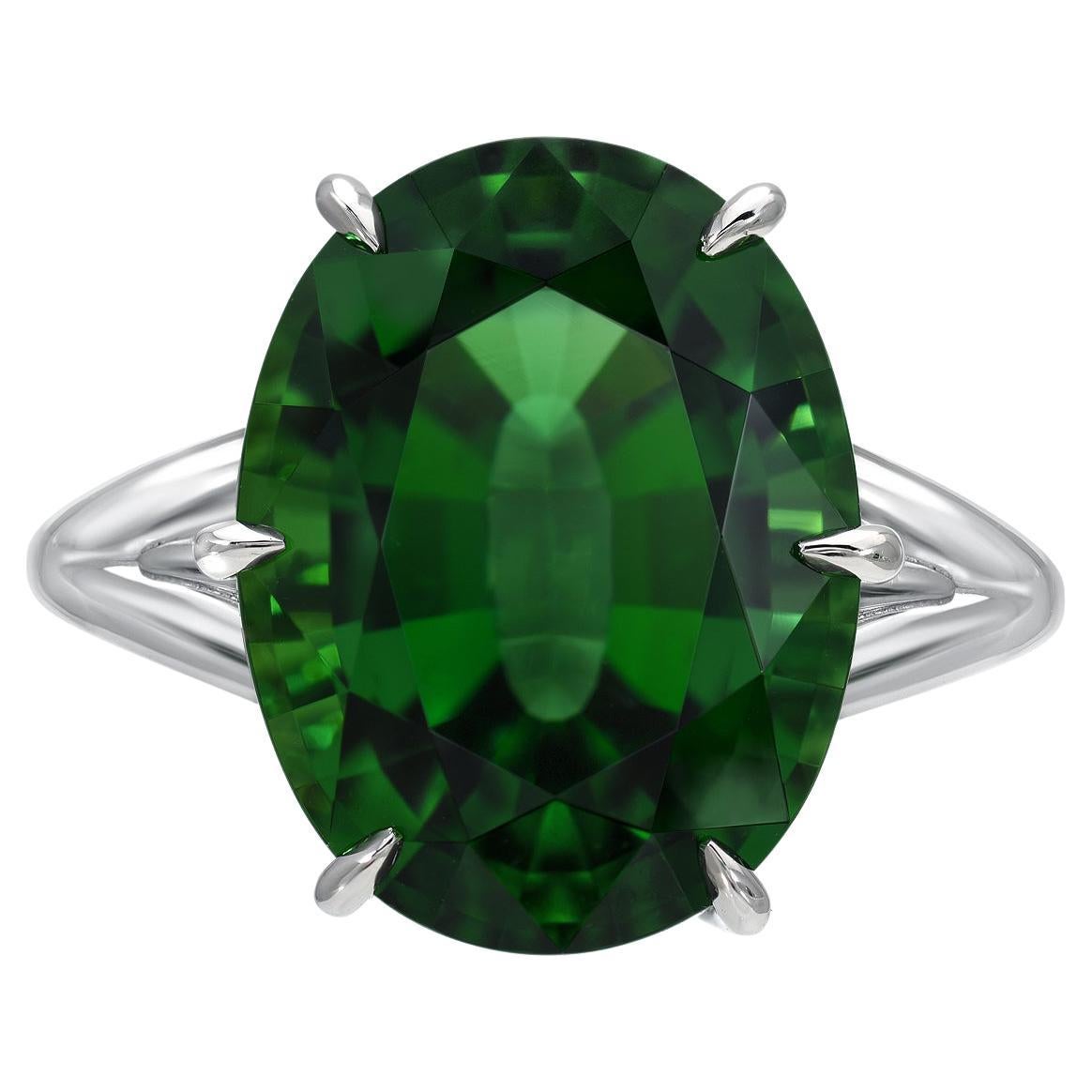 This rare and exceptional 7.70 carat Chrome Tourmaline oval, is set in a ultra fine 6 claw prong setting, and adorned by a total of 0.26 carat round brilliant diamonds, to compose this hand crafted platinum ring. This gem exhibits superior color,