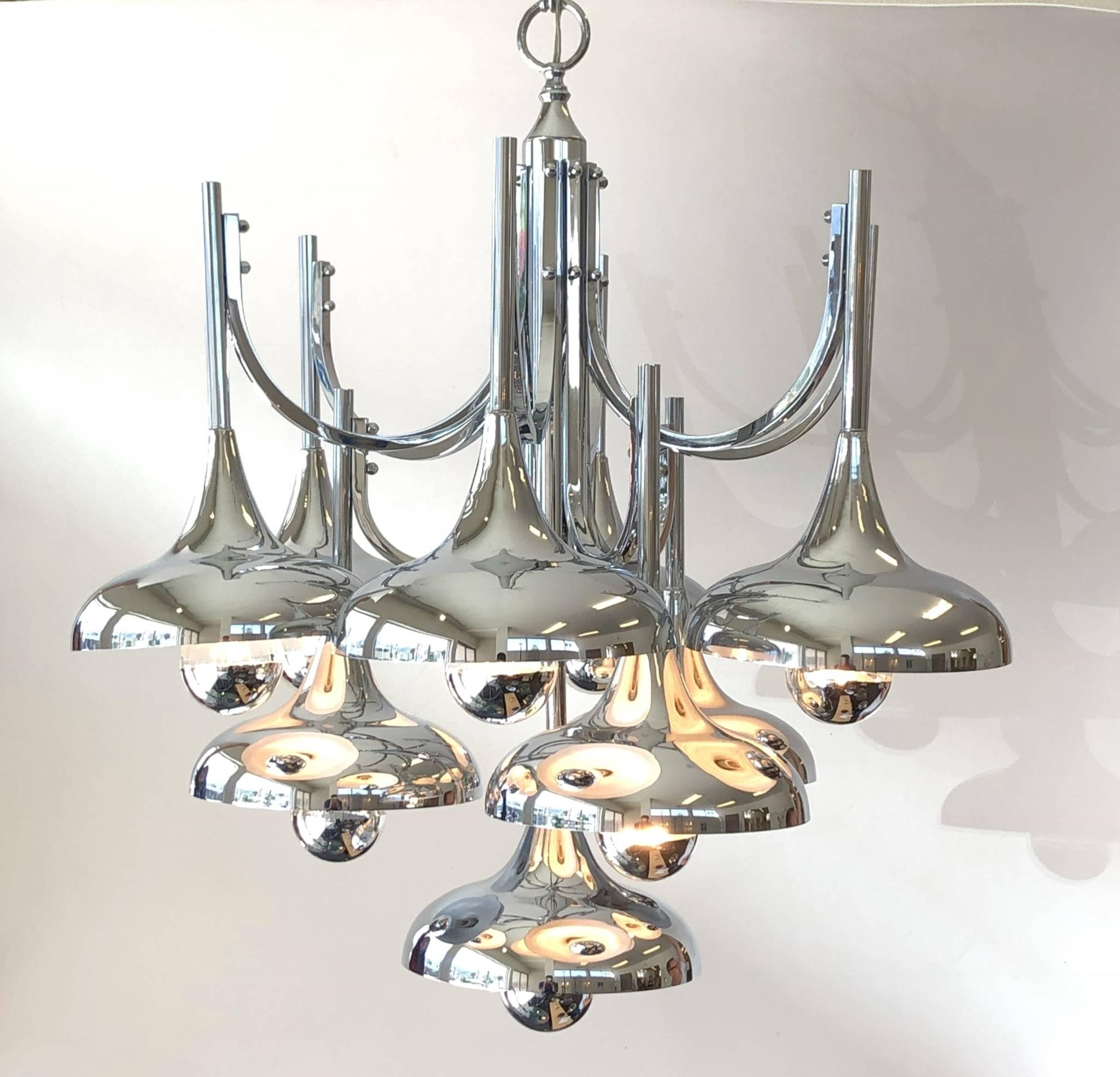 A glamorous polish chrome and white lacquer hanging chandelier designed by Lightolier in the 1970s. The chandelier is designed out of ten trumpet shape pendants and it takes ten regular Edison lightbulbs.( shown with chrome dipped bulb)
Newly