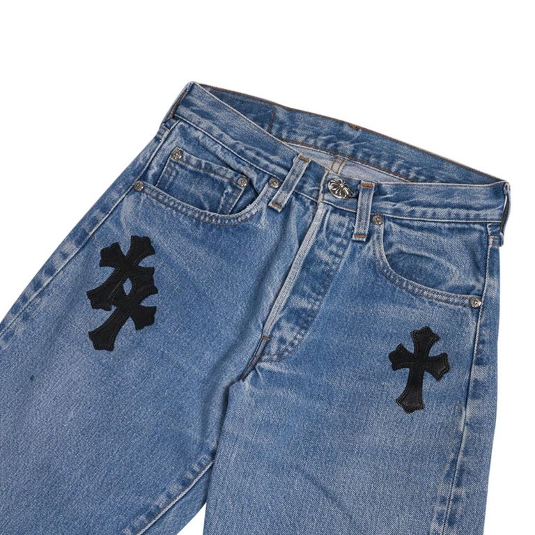 Guaranteed authentic Chrome Hearts x Levi Strauss appliqued jean.  
Medium wash jean with Signature Chrome Hearts black cross leather appliques.
Logo button fly.
Logo studs and top button. 
Metal Chrome Hearts plaque at rear.
Levi Strauss plaque at