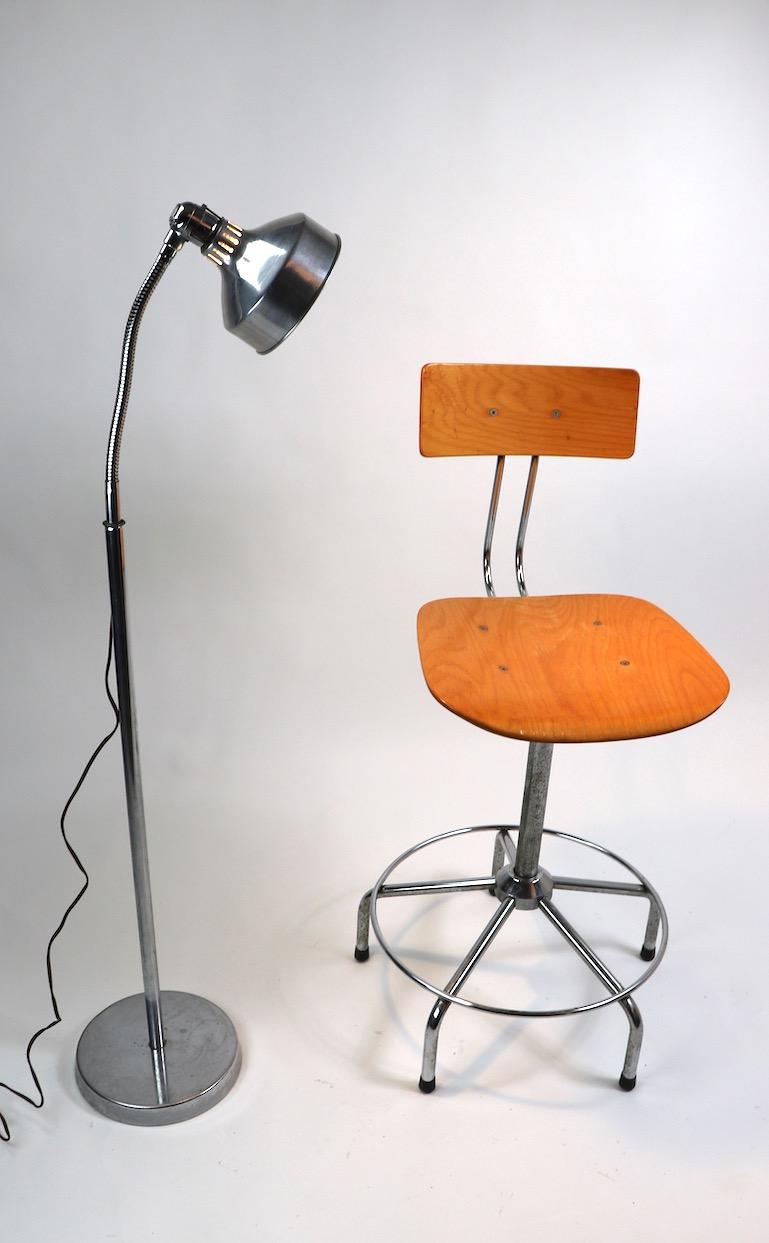 Nice chrome gooseneck floor lamp by Ajusco, This example is adjustable in height (57 highest x lowest 39 inch ) The hood shade will pivot to more precisely direct the light. Original, clean, and working condition, accepts standard screw in