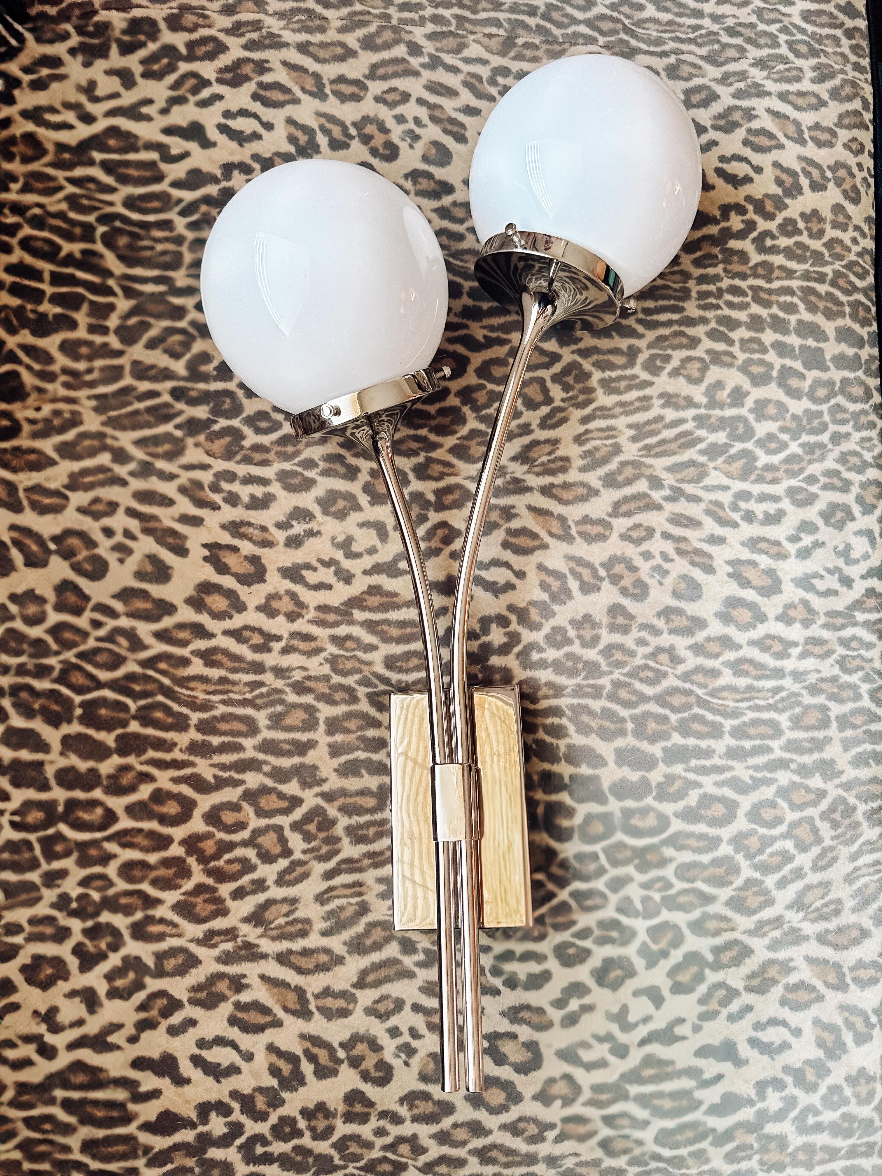 Elevate your space with this striking Kate Spade New York wall sconce, crafted in 2025 and produced by Visual Comfort. Featuring a sleek polished chrome frame and two elegant white glass globes, this piece blends timeless sophistication with modern