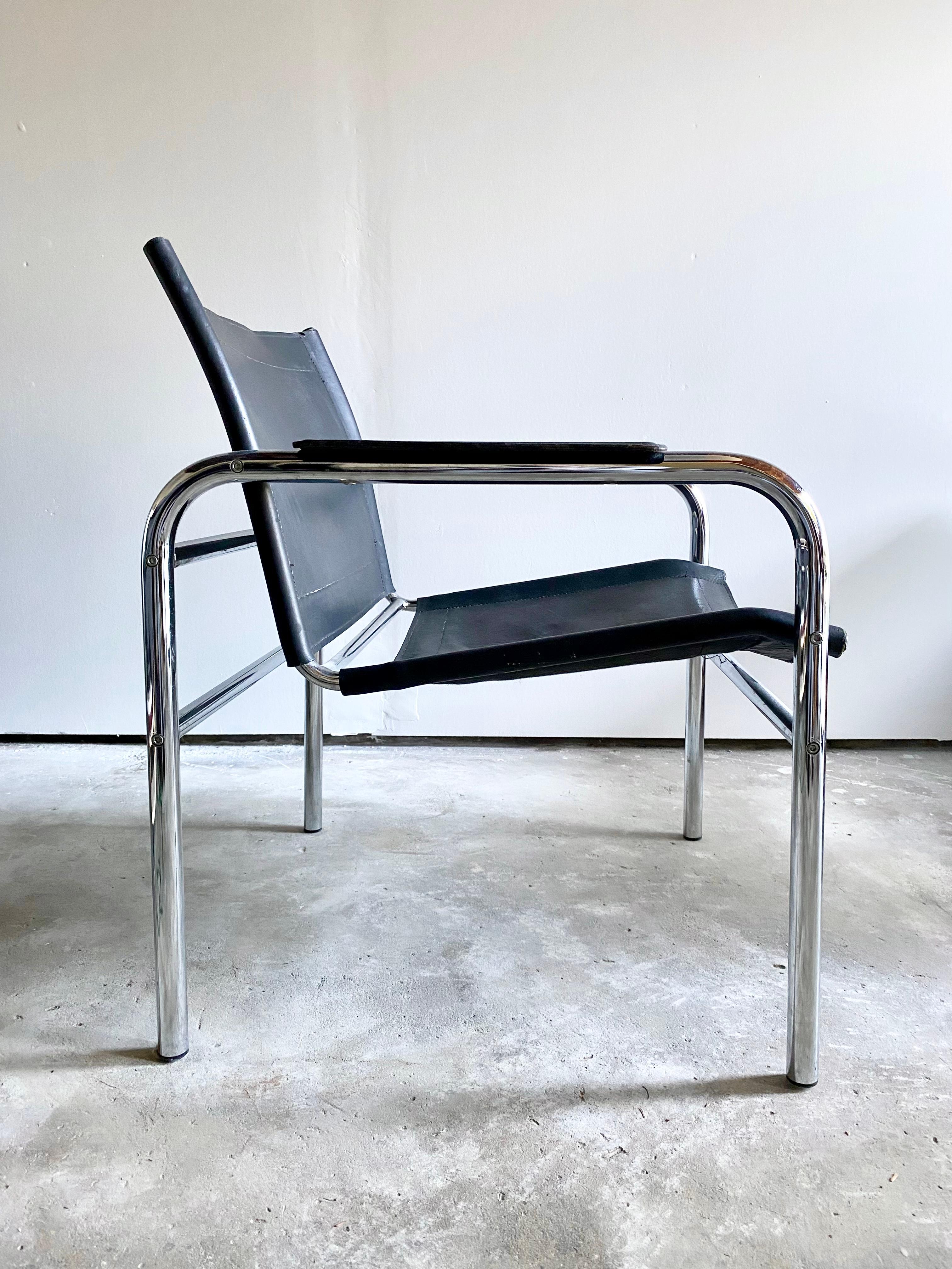 Straying from the chrome cantilever chair, this slung leather chair on a chrome frame sits elegantly, and provides surprising comfort. A minimalist statement with very few deviations from it's very concise line, with a very beautiful profile.