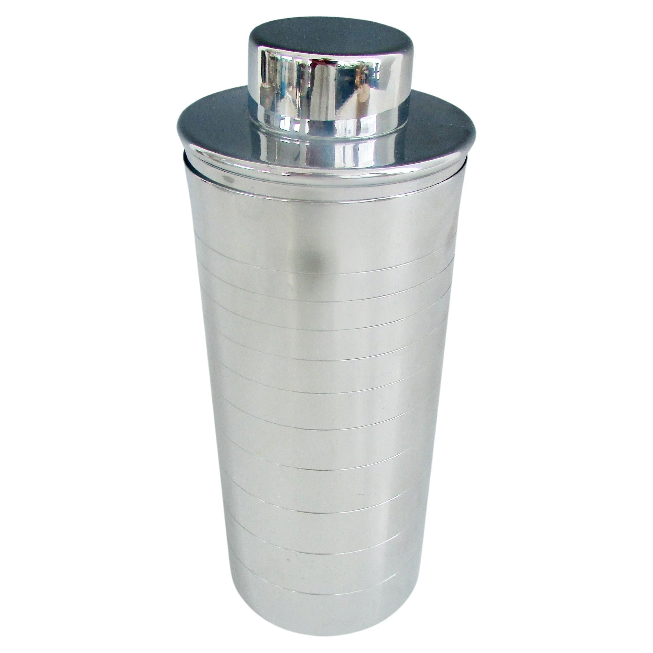 Classic chrome cylinder cocktail shaker with two piece removable lid. Very clean original no dents or dings. Possibly never used. Chrome is exceptionally clean without any pitting.